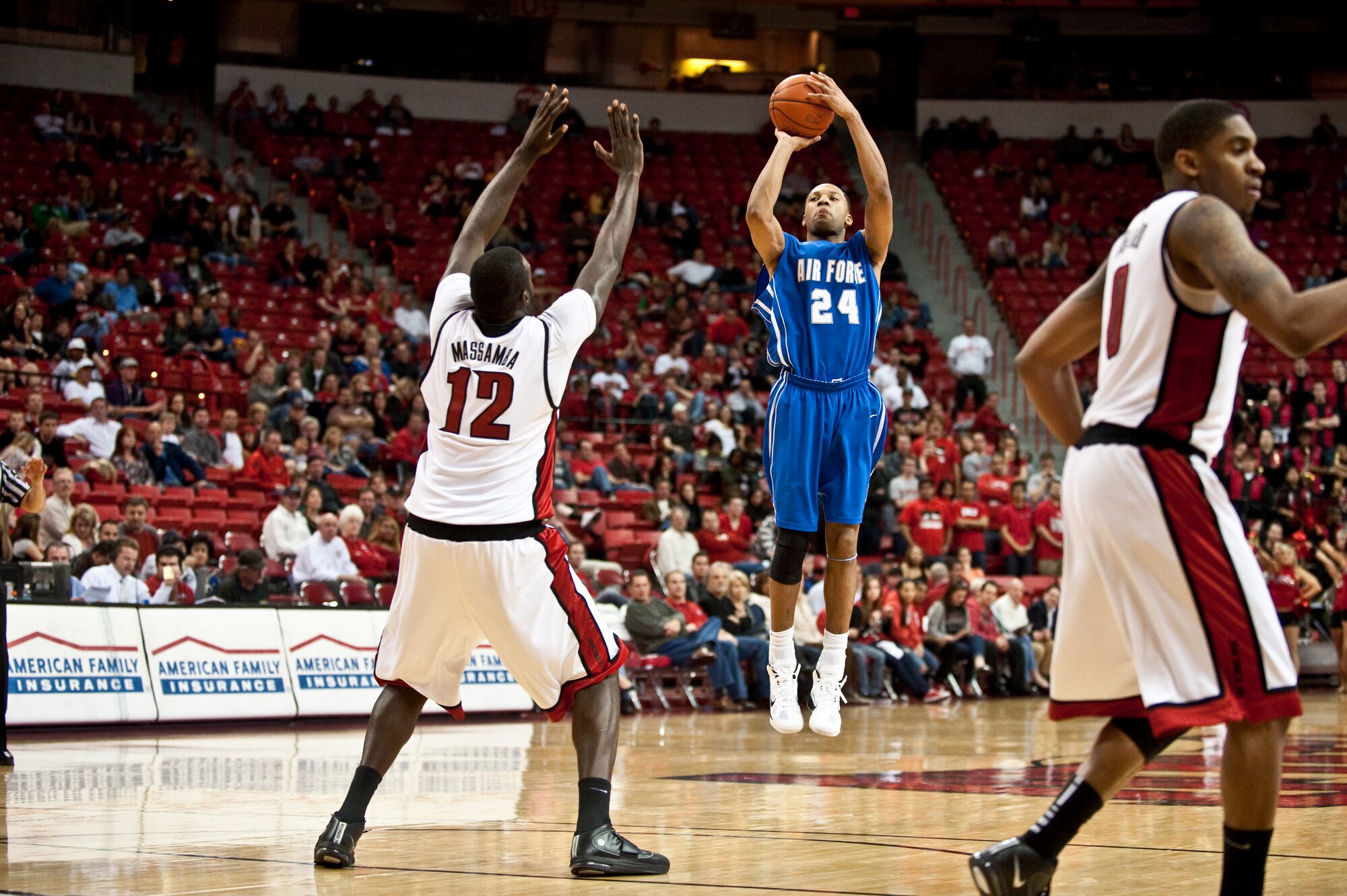 LAS VEGAS --  Derek Brooks, U.S. Air Force Academy "Falcons" senior forward, shoots a three point shot over the out stretched arms of Brice Massamba, University of Nevada Las Vegas "Runnin' Rebels" junior center at the Thomas and Mac Center Feb. 15. The Air Force Falcons came up short against  UNLV 49-42, making their record 13-11 overall and 4-7 in the Mountain West Conference. (U.S. Air Force photo by Tech Sgt. Michael R. Holzworth)
