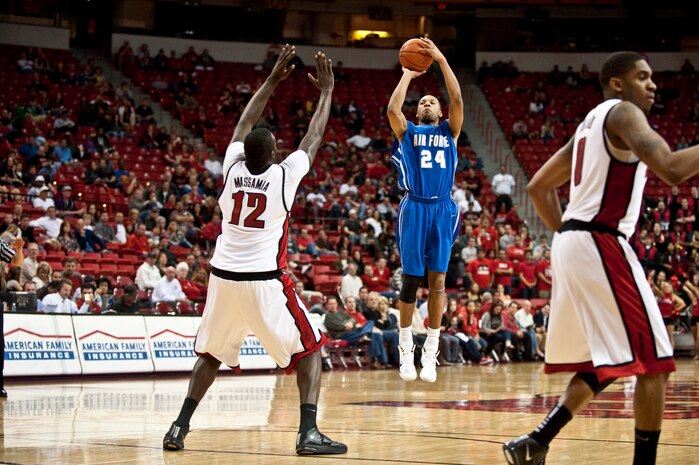 LAS VEGAS --  Derek Brooks, U.S. Air Force Academy "Falcons" senior forward, shoots a three point shot over the out stretched arms of Brice Massamba, University of Nevada Las Vegas "Runnin' Rebels" junior center at the Thomas and Mac Center Feb. 15. The Air Force Falcons came up short against  UNLV 49-42, making their record 13-11 overall and 4-7 in the Mountain West Conference. (U.S. Air Force photo by Tech Sgt. Michael R. Holzworth)