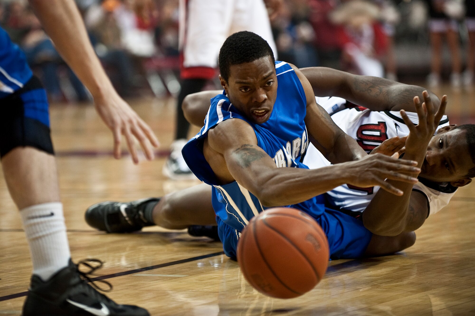 LAS VEGAS --  Evan Washington, U.S. Air Force Academy "Falcons" senior guard, dives for a loose ball early in the first half of a mountain west conference basketball game against the University of Nevada Las Vegas "Runnin' Rebels" at the Thomas and Mac Center Feb. 15. The Air Force Falcons came up short against  UNLV 49-42, making their record 13-11 overall and 4-7 in the Mountain West Conference. (U.S. Air Force photo by Tech Sgt. Michael R. Holzworth)
