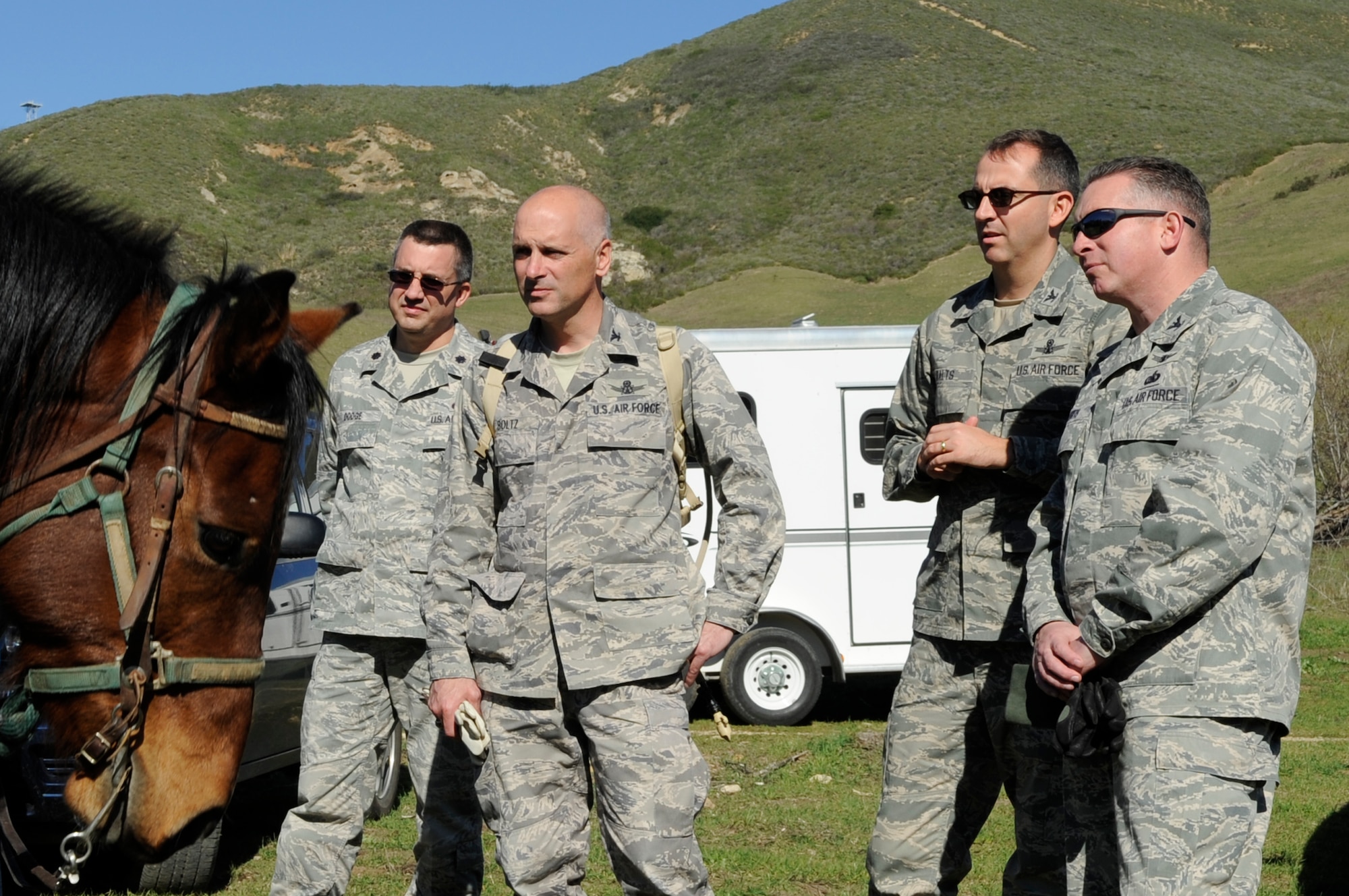 VANDENBERG AIR FORCE BASE, Calif. – (From left) Lt. Col. Timothy Dodge, the 30th Civil Engineer Squadron commander, Col. Richard Boltz, the 30th Space Wing commander, Col. Keith Balts, the 30th Space Wing vice-commander, and Col. Kelly Kirts, the 30th Mission Support Group commander, receive a briefing about the base’s patrol horses here Wednesday, Feb. 9, 2011. The horses are used to patrol the base’s rugged terrain from its beaches to hillsides. (U.S. Air Force photo/Airman 1st Class Lael Huss)