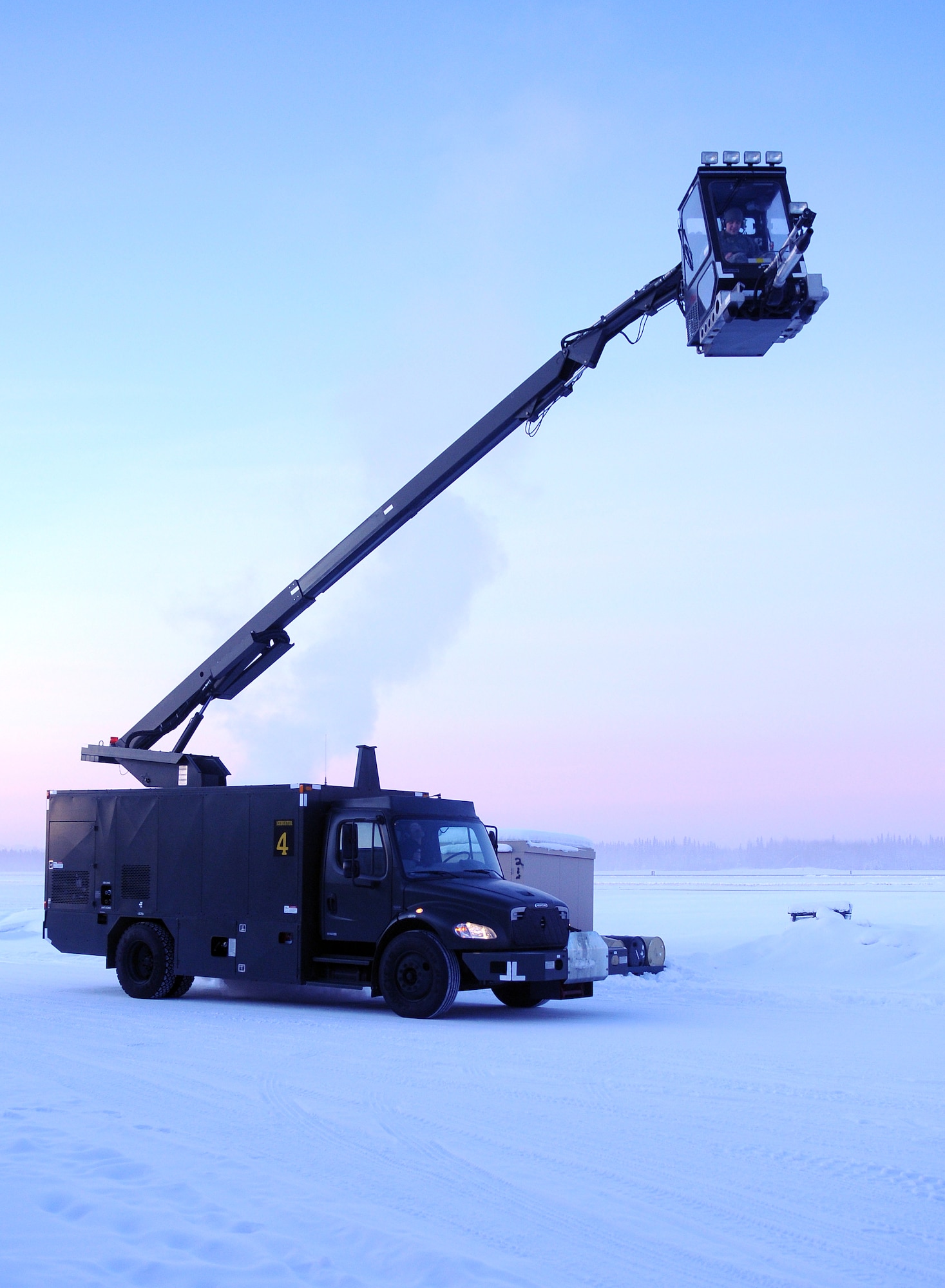 De-icer operators check lift controls Feb. 16, 2011, Eielson Air Force Base, Alaska. The operators are assigned to the 354th Maintenance Squadron aerospace ground equipment flight. (U.S. Air Force photo/Airman 1st Class Janine Thibault)