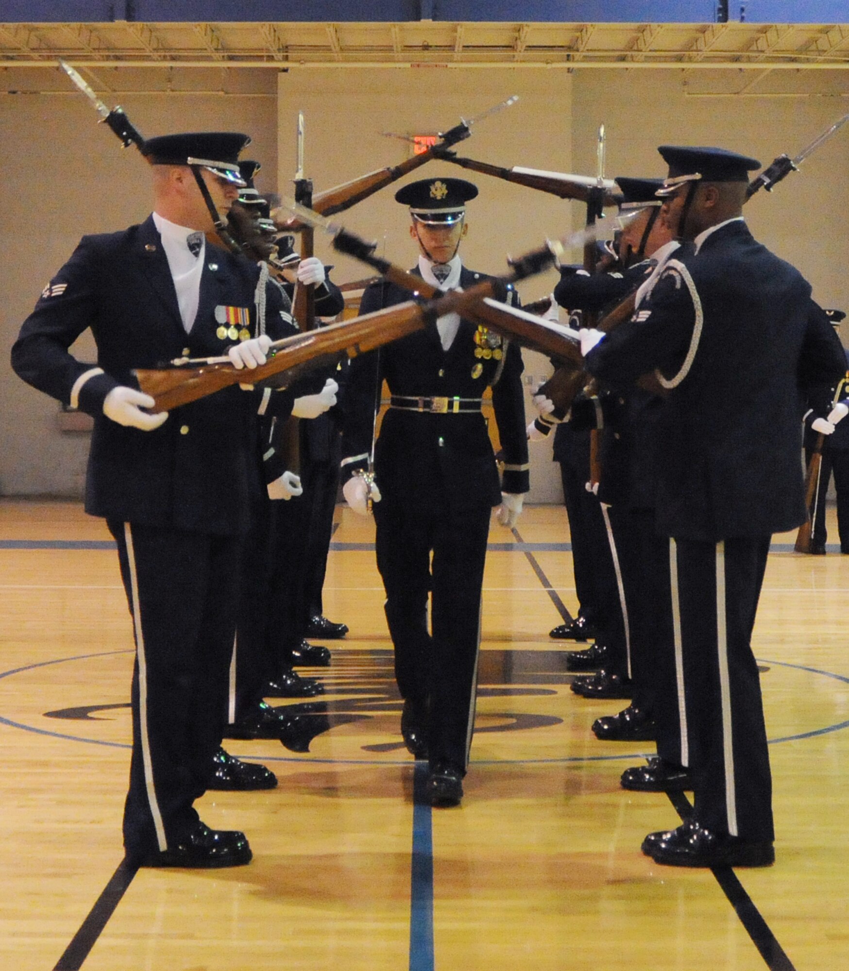 Members of the U.S. Air Force Honor Guard Drill Team perform for Team McConnell members Feb. 14, 2011, McConnell Air Force Base, Kan. A standard 16-person performance features a choreographed routine of weapon maneuvers, precise rifle tosses, complex weapon exchanges and a walk through a gauntlet of spinning weapons. (U.S. Air Force photo/Airman 1st Class Katrina M. Brisbin)