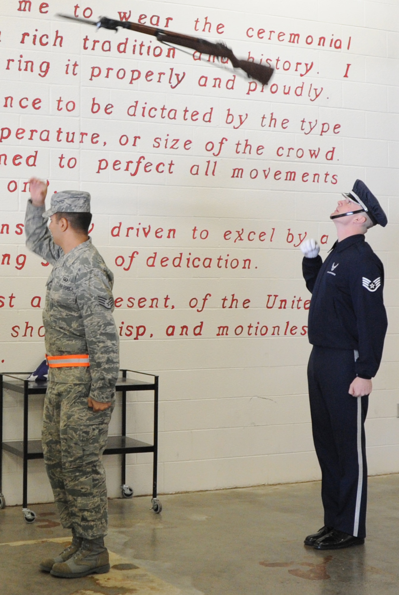 Staff Sgt. David Perry, 22nd Air Refueling Wing religious program support NCOIC, a former U.S. Air Force Honor Guard Drill Team member, performs a back to back toss with Staff. Sgt Kelly Webster, U.S. Air Force Honor Guard Drill Team NCOIC, Feb. 14, 2011, McConnell Air Force Base, Kan. Sergeant Kelly was born and raised in Derby, Kan. (U.S. Air Force photo/Airman 1st Class Katrina M. Brisbin)
