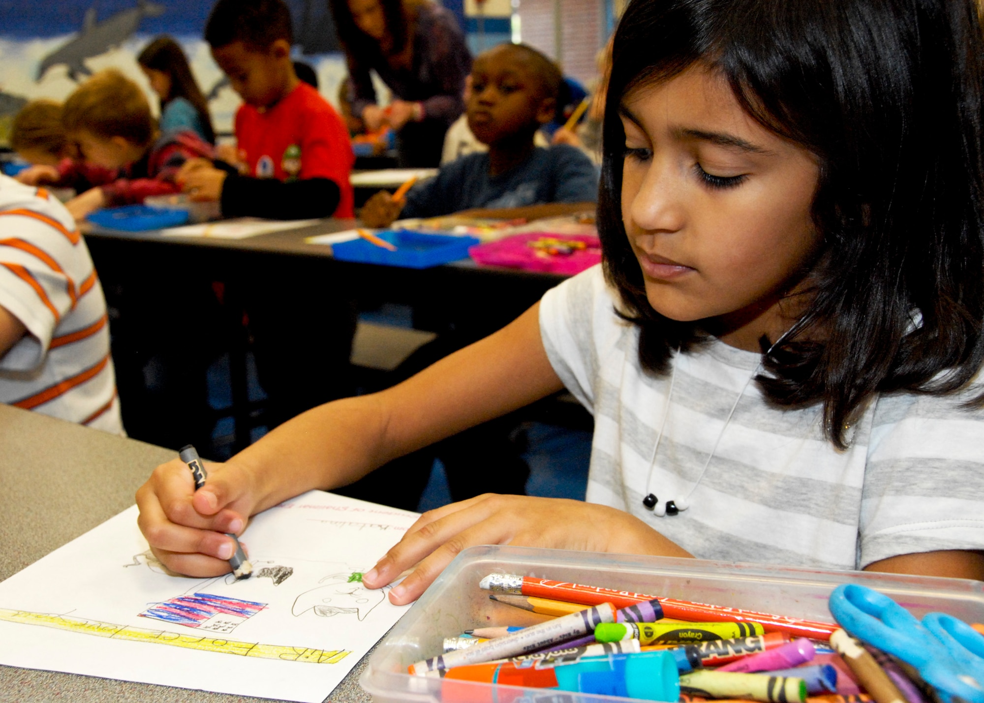 Katalina Moore concentrates on coloring her thank-you card Feb. 16 at Shalimar Elementary. First grade students made cards for local retired service-members who were injured during their time of service. More than 90 thank you cards will be handed out at the VFW Post 7674 in Fort Walton, Beach, Fla., Feb. 21st. (U.S. Air Force photo/Sachel Seabrook)