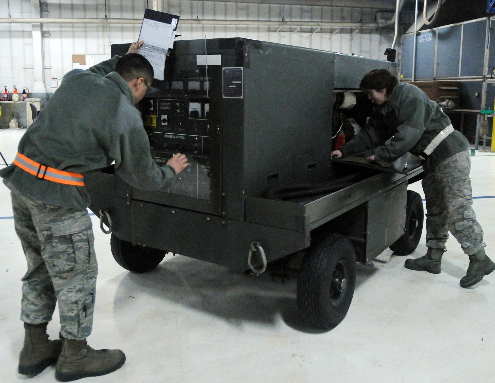 Airman 1st Class Angel Marquez and Airman 1st Class Sheldy Forton perform a service inspection on an essex power generator Feb. 16, 2011, Eielson Air Force Base, Alaska. Airmen periodicaly inspect equipment to ensure it is ready for maintainers to use during aircraft operations. The Airmen are assigned to the 354th Maintenance Squadron as aerospace ground equipment maintainers. (U.S.Air Force photo/Airman 1st Class Janine Thibault)