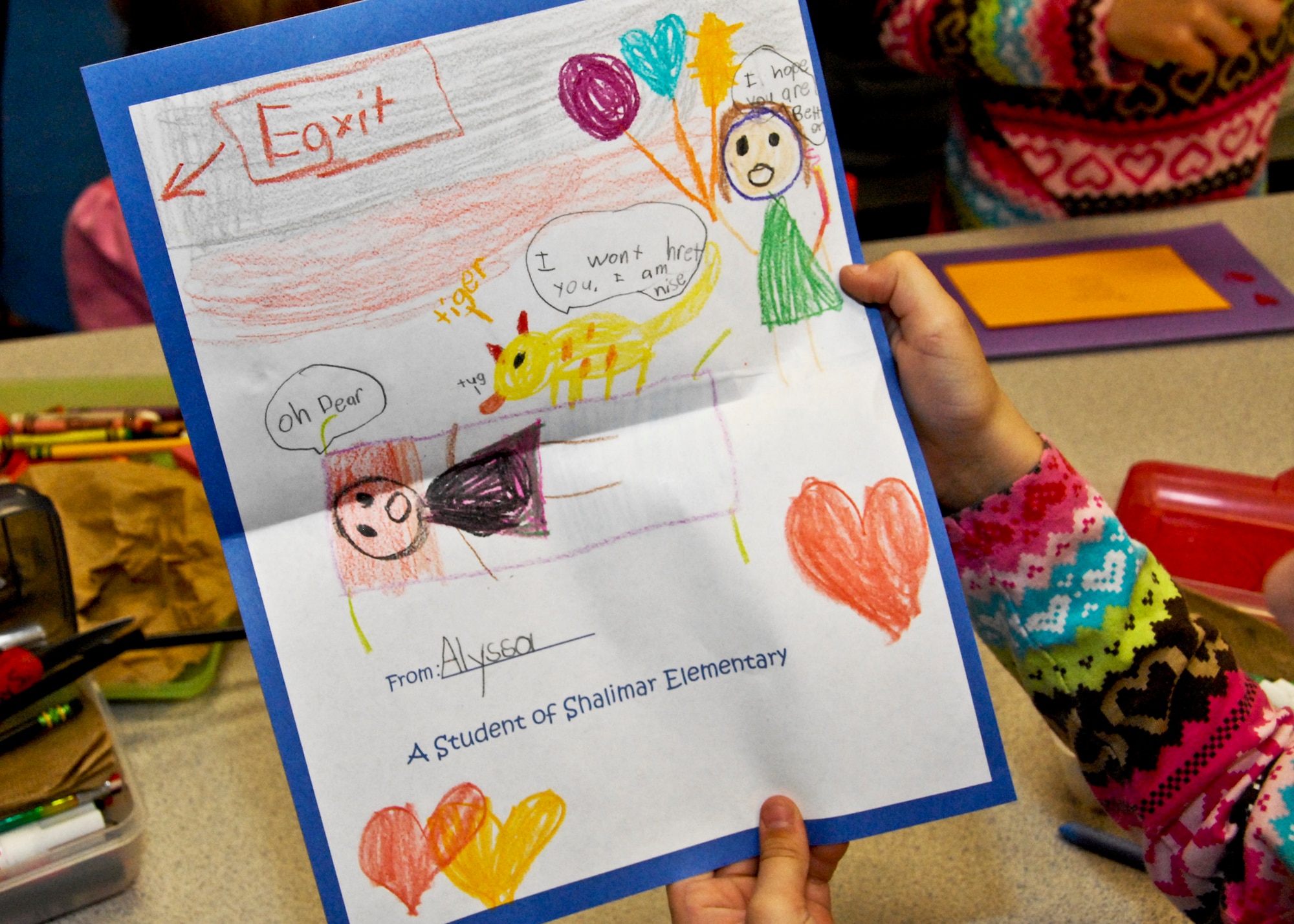 Alyssa Cooper proudly shows her colorful thank-you card Feb. 16 at Shalimar Elementary. First grade students made cards for local retired service-members who were injured during their time of service. More than 90 thank you cards will be handed out at the VFW Post 7674 in Fort Walton, Beach, Fla., Feb. 21st. (U.S. Air Force photo/Sachel Seabrook)