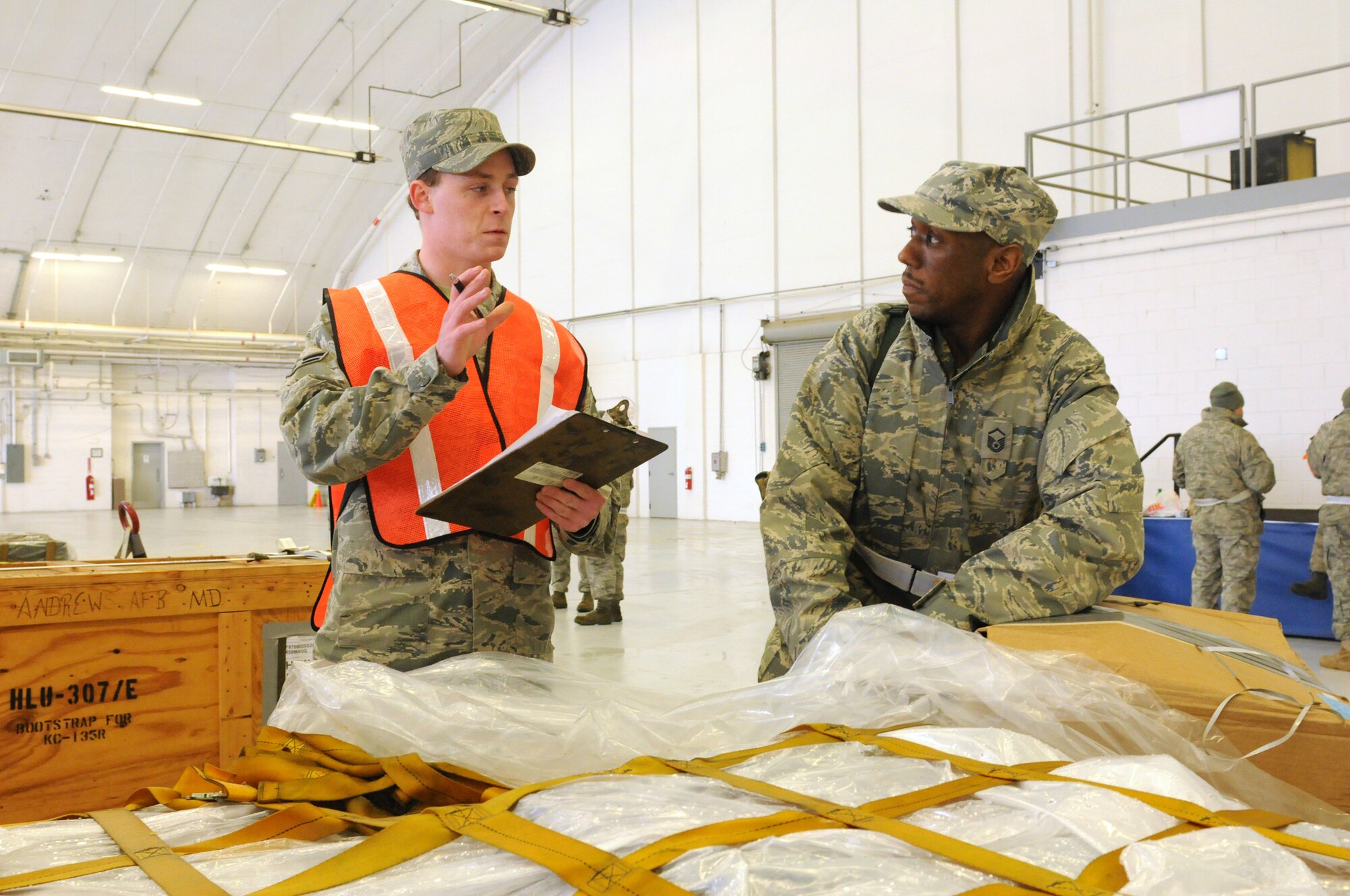 JOINT BASE ANDREWS, Md. -- Airman First Class Troy Tolfree (left), 11th Logistics Readiness Squadron, reviews pallet inspection items with Master Sgt. Alfred McDuffie, 459th Operations Support Flight, during a cargo proceesing and mobility exercise Feb. 5 here.  Along with preparing cargo for airlift, 459th Air Refueling Wing Reservists also faced scenarios like understanding alarm signals, donning Chemical Protective Overgarments and searching for Unexploded Ordinance during exercise Vantage Rally/Tiger Claw 11-01. The 459 ARW also worked alongside the active duty 11 WG and the 89 WG during the exercise in order to prepare for an upcoming Operational Readiness Inspection. (U.S. Air Force photo/Tech. Sgt. Steve Lewis)