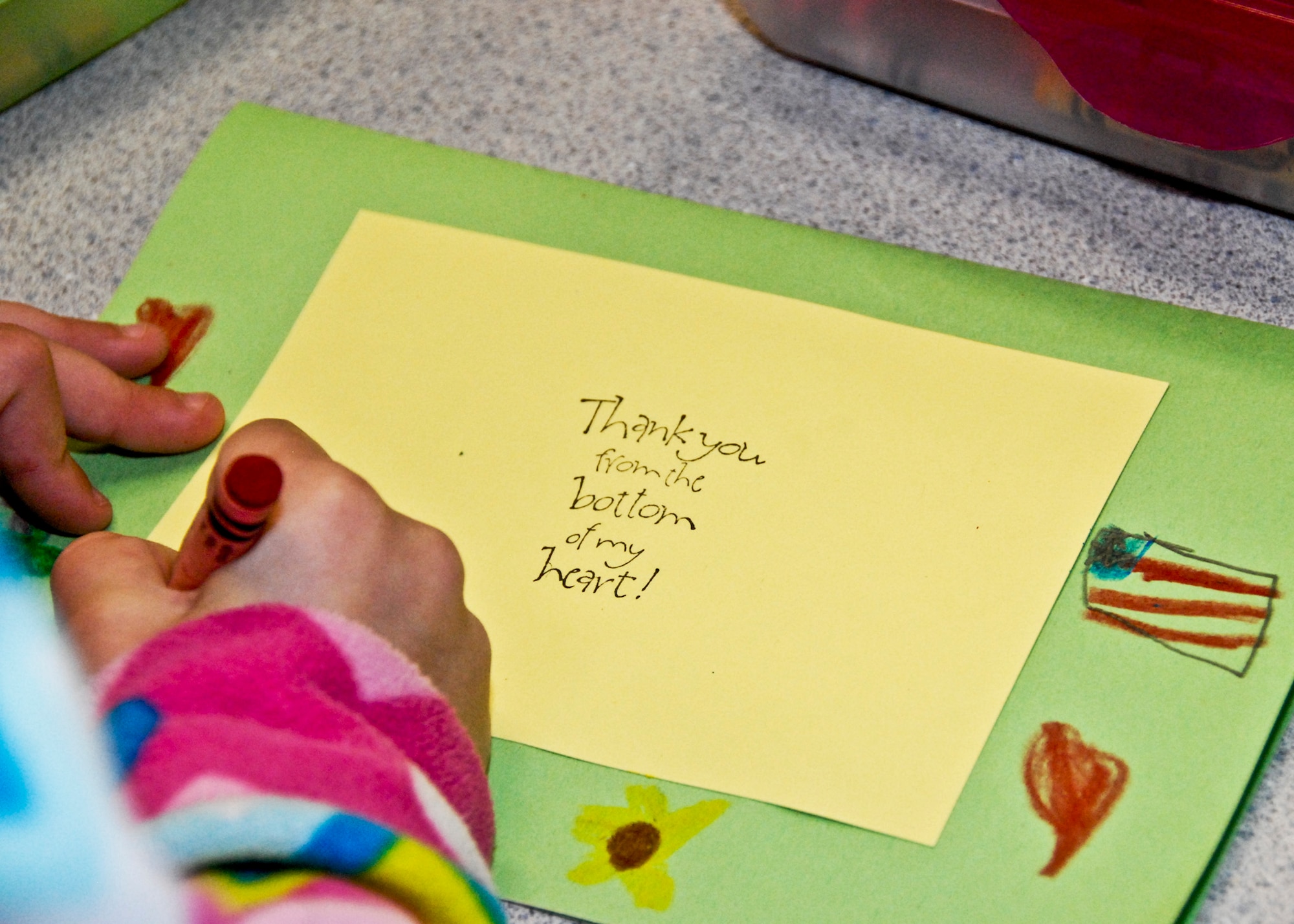 A first grade student carefully colors a thank-you card Feb. 16 at Shalimar Elementary. First grade students made cards for local retired service-members who were injured during their time of service. More than 90 thank you cards will be handed out at the VFW Post 7674 in Fort Walton, Beach, Fla., Feb. 21st. (U.S. Air Force photo/Sachel Seabrook)