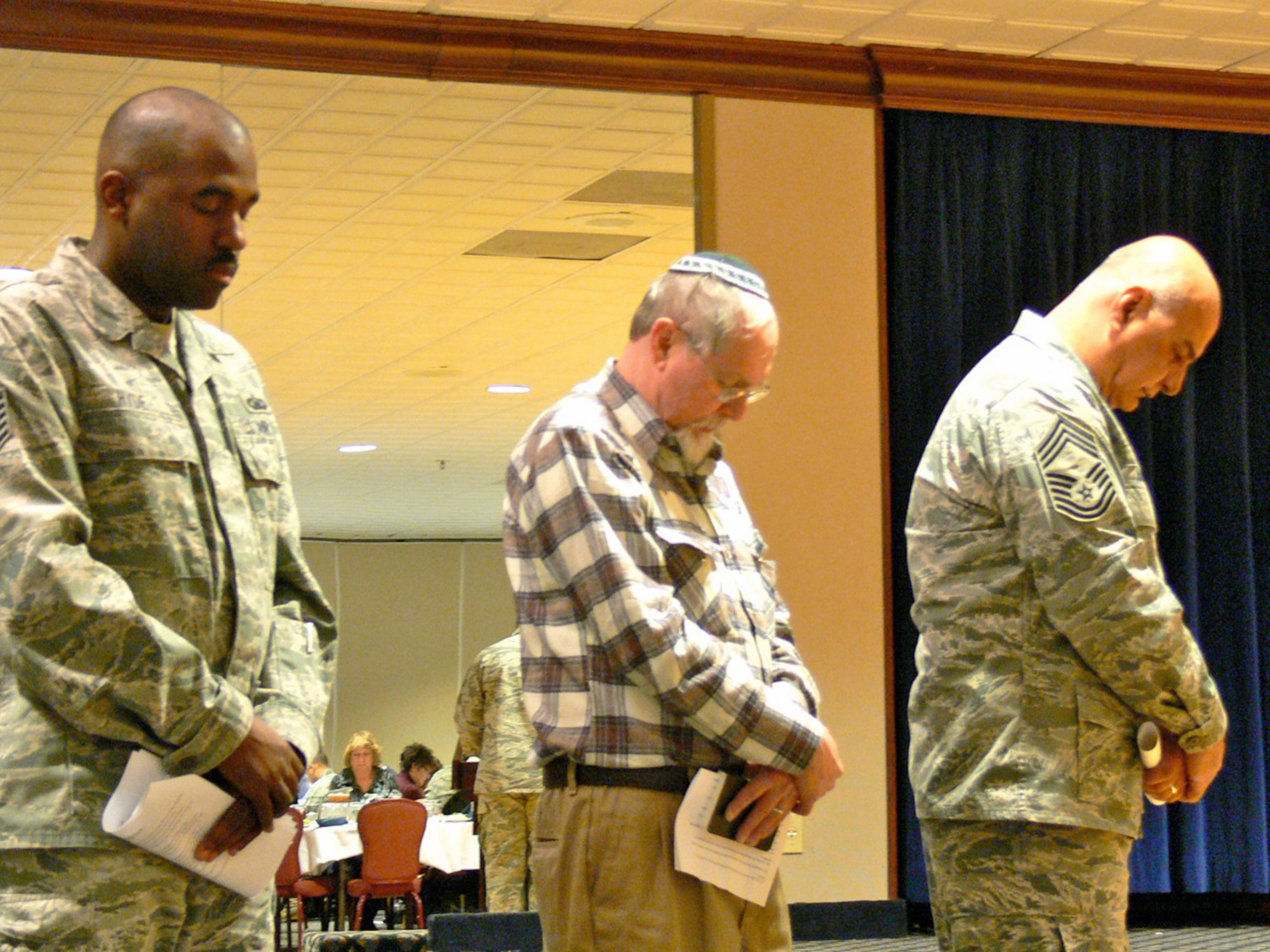 The Peterson Air Force Base National Prayer Luncheon, Feb. 10 at The Club, opened with prayers from (from left) Tech. Sgt. Shayne Hyde, 21st Space Wing noncommissioned officer in charge of chapel readiness; Louis Steinberg, Peterson Air Force Base Jewish lay leader; and Chief Master Sgt. Ibrahim Hamdan, 21st Force Support Squadron Sustainment Services Flight. Sergeant Hyde read from Christian scripture, Mr. Steinberg gave a Hebrew reading and Chief Hamdan read a Muslim prayer in Arabic. In 1953, members of the U.S. Senate and House, with President Dwight D. Eisenhower, established the first National Prayer Breakfast. (U.S. Air Force photo/Monica Mendoza)