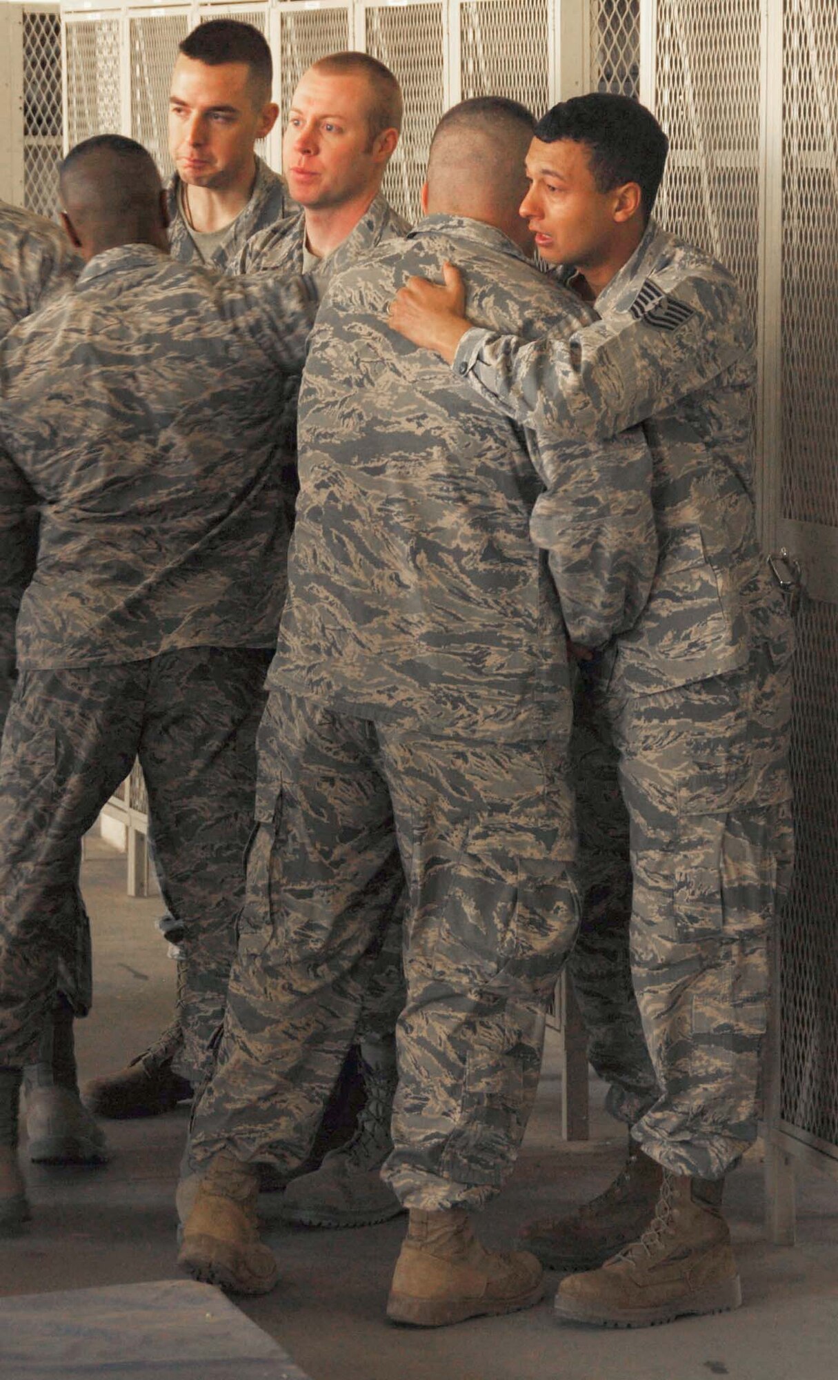 Deployed firefighters from Kadena Air Base, Japan, mourn the loss of Senior Airman Derek Kozorosky during a memorial ceremony Feb. 16, 2011, in Southwest Asia. Airman Kozorosky died Feb. 11, 2011, at Kadena Air Base, Japan, following a vehicle incident. (U.S. Air Force photo/Staff Sgt. Anthony Graham)
