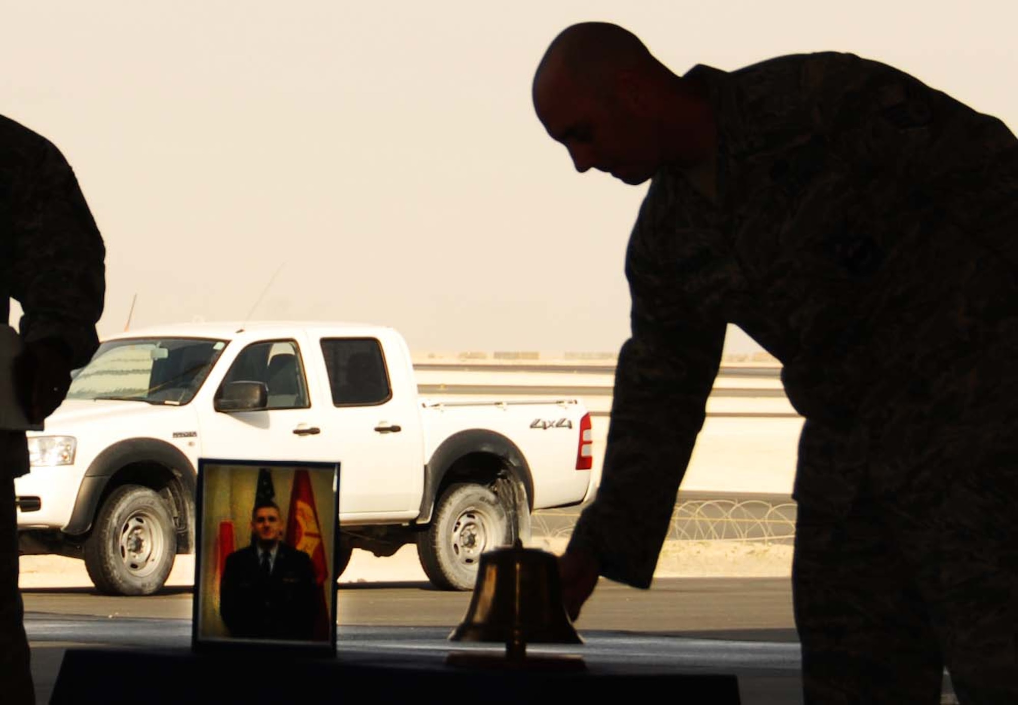 A firefighter assigned to the 379th Expeditionary Civil Engineer Squadron Fire Protection Flight, rings the final alarm for Senior Airman Derek Kozorosky, a fallen firefighter, during a memorial service Feb. 16, 2011, in Southwest Asia. Airman Kozorosky died Feb. 11, 2011, after a vehicle incident at Kadena Air Base, Japan. (U.S. Air Force photo/Staff Sgt. Anthony Graham)