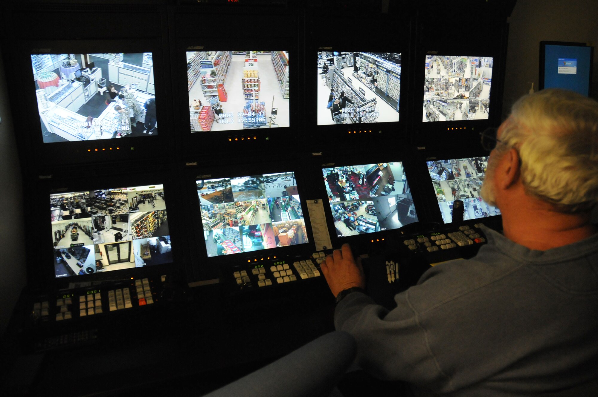 Michael Diot, AAFES loss prevention manager, toggles between various camera angles throughout the exchange as he keeps watch for suspicious shoplifting behavior. With more than 100 cameras, AAFES security and safety associates are
able to keep an eye on almost every square inch of the store.  (U.S. Air Force photo by Kemberly Groue)