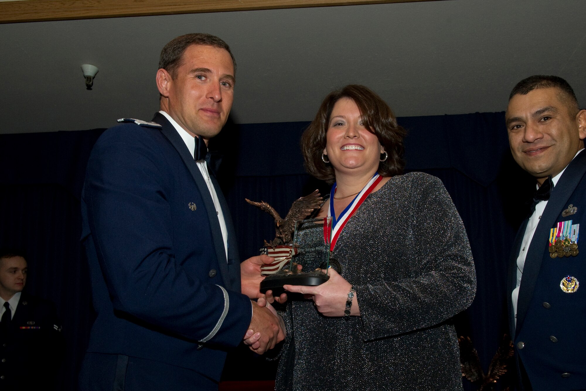 HOLLOMAN AIR FORCE BASE, N.M. -- Teresa Wells receives the 49th Wing Key Spouse of the Year award from Col. David Krumm, 49th Wing commander, during the Wing’s Annual Awards Ceremony, Feb. 11. Ms. Wells oversaw the group spouse’s haunted house fundraiser, which raised $3,400 for morale events. Additionally, she collected and sorted items for more than 400 care packages and distributed them to deployed Airmen. The nominees for Key Spouse of the Year were Ms. Wells, Tina Keene, Nicole Krebs and Jamie Sherwood. (U.S. Air Force photo by Airman 1st Class Eileen Payne and Airman 1st Class Joshua Turner/Released)