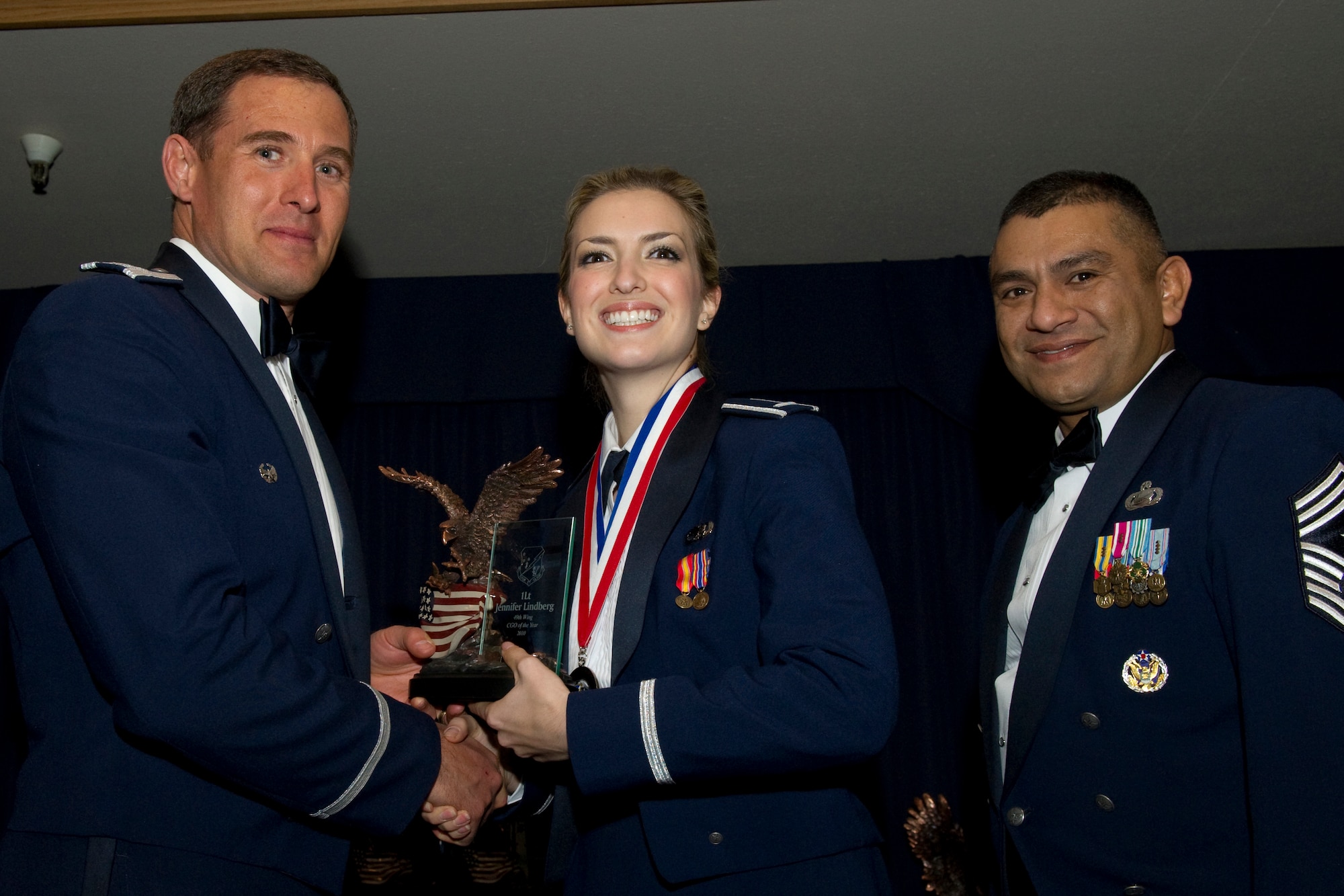 HOLLOMAN AIR FORCE BASE, N.M. -- 1st Lt. Jennifer Lindberg, 49th Maintenance Group, receives the Company Grade Officer of the Year award from Col. David Krumm, 49th Wing commander, during the Wing’s Annual Awards Ceremony, Feb. 11. Lieutenant Lindberg led 200 Airmen across seven Air Force specialty codes and managed 28 F-22 aircraft valued at $4 billion. Additionally, she balanced a $266 million flying hour program while serving as the aircraft maintenance unit officer in charge. Furthermore, she led a 12-ship deployment to Red Flag - Nellis where she maintained a 91 percent mission capable rate enabling the best-to-date kill ratio of 44 to one. The nominees for CGO of the Year were Lieutenant Lindberg; Capt. Adrian Simental, 49th Materiel Maintenance Group; Capt. Dawn Rose, 49th Medical Group; Capt. Heidi Baker, 49th Mission Support Group; Capt. Dean Korsak, 49th Wing Staff; and Maj. Brandon Tellez, 49th Operations Group. (U.S. Air Force photo by Airman 1st Class Eileen Payne and Airman 1st Class Joshua Turner/Released)