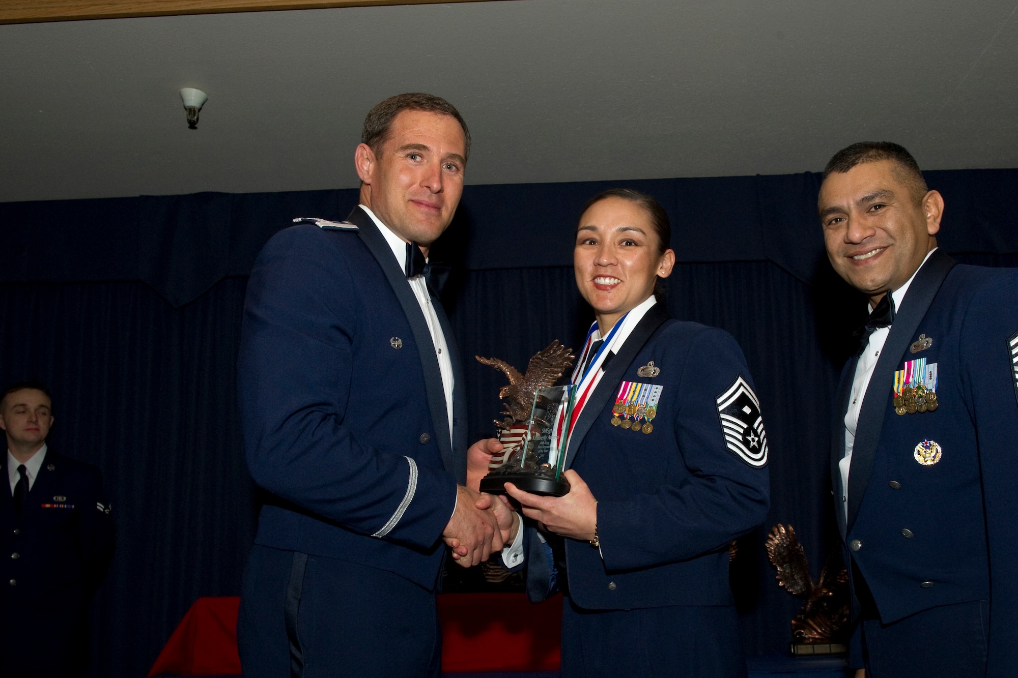 HOLLOMAN AIR FORCE BASE, N.M. -- Senior Master Sgt. Kimberly Armijo, 49th Maintenance Group, receives the First Sergeant of the Year award from Col. David Krumm, 49th Wing commander, during the Wing’s Annual Awards Ceremony, Feb. 11. Sergeant Armijo protected the Air Force’s most valuable resources by skillfully diffusing five volatile domestic disputes. Additionally, she coordinated critical follow-up care and recovery of three distraught Airmen after attempts of suicide. Furthermore, she was awarded her bachelor’s degree and received the Distinguished Graduate Award upon graduation from the Senior NCO Academy. The nominees for First Sergeant of the Year were Sergeant Armijo; Master Sgt. Steven Reynolds, 49th Materiel Maintenance Group; Master Sgt. Melissa Tarango, 49th Medical Group; Master Sgt. Bryan Butler, 49th Mission Support Group; and Master Sgt. David Kalal, 49th Operations Group. (U.S. Air Force photo by Airman 1st Class Eileen Payne and Airman 1st Class Joshua Turner/Released)