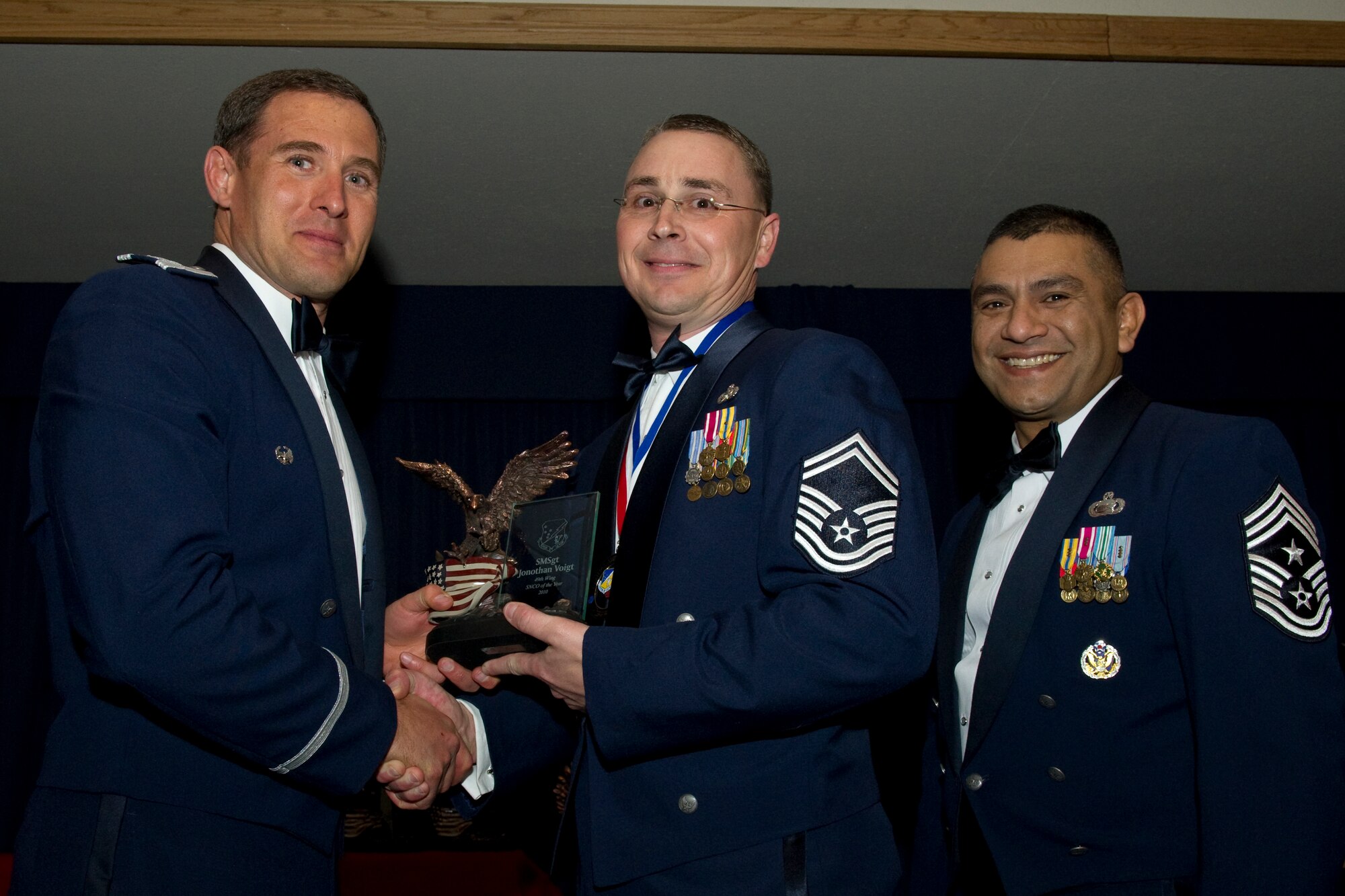 HOLLOMAN AIR FORCE BASE, N.M. -- Senior Master Sgt. Jonothan Voigt, 49th Mission Support Group, receives the Senior NCO of the Year award from Col. David Krumm, 49th Wing commander, during the Wing’s Annual Awards Ceremony, Feb. 11. Sergeant Voigt served as fuels management flight chief, where he led 75 personnel and managed a 15 million gallon fuel account valued at more than $41 million. He championed his flight to success, where they were selected number one of 15 bases in Air Combat Command as the Drake American Petroleum Institute Award winners. These efforts culminated in his selection as the wing’s Senior NCO of the second quarter. The nominees for Senior NCO of the Year were Sergeant Voigt; Senior Master Sgt. James Cupp, 49th Materiel Maintenance Group; Senior Master Sgt. Shawn Hughes, 49th Maintenance Group; Senior Master Sgt. William Cisna, 49th Medical Group; Master Sgt. Tammy Moore, 49th Wing Staff; and Master Sgt. Glenn Estrada, 49th Operations Group. (U.S. Air Force photo by Airman 1st Class Eileen Payne and Airman 1st Class Joshua Turner/Released)