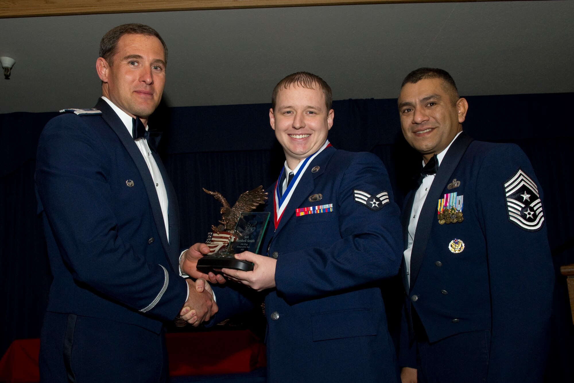 HOLLOMAN AIR FORCE BASE, N.M. -- Senior Airman Hershell Smith, 49th Operations Group, receives the Airman of the Year award from Col. David Krumm, 49th Wing commander, during the Wing’s Annual Awards Ceremony, Feb. 11. Airman Smith labored 90 hours, supporting 15 combat sortie missions which provided real-time, full-motion video intelligence with zero coalition losses during overseas contingency operations. Additionally, he earned his Bachelor of Science degree and was awarded the John Levitow Award upon graduation from Airman Leadership School. The nominees for Airman of the Year were Airman Smith; Airman 1st Class Justin Boyden, 49th Materiel Maintenance Group; Airman 1st Class Cameron James, 49th Maintenance Group; Senior Airman Lerma Orara, 49th Medical Group; Senior Airman Jeffrey Derrick, 49th Mission Support Group; and Senior Airman Vincent Bulatoa, 49th Wing Staff. (U.S. Air Force photo by Airman 1st Class Eileen Payne and Airman 1st Class Joshua Turner/Released)