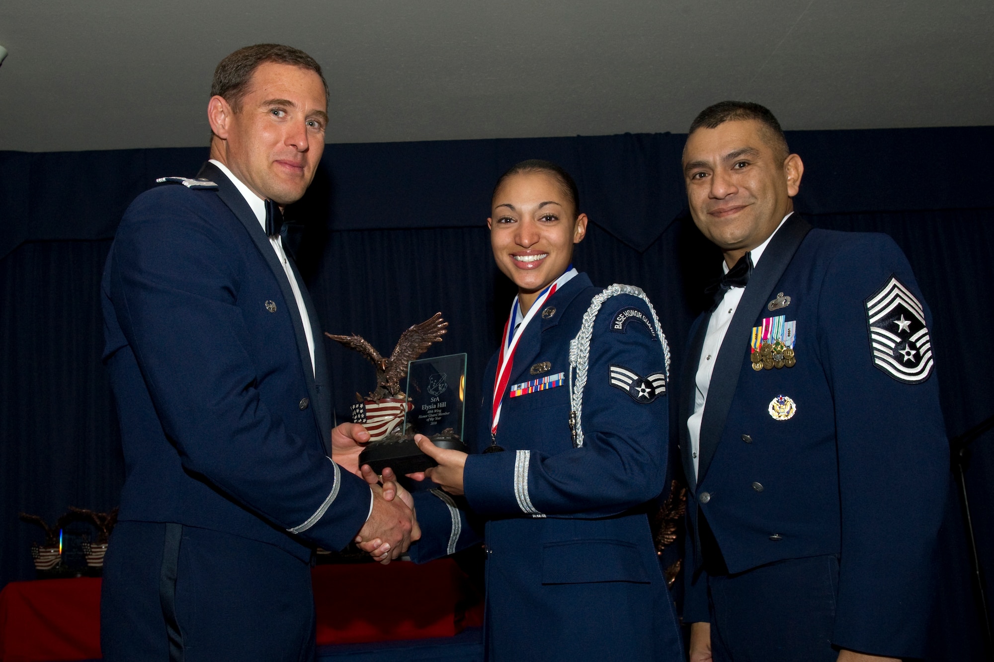 HOLLOMAN AIR FORCE BASE, N.M. -- Senior Airman E’lysia Hill, 49th Maintenance Group, receives the Honor Guard member of the Year award from Col. David Krumm, 49th Wing commander, during the 49th Wing Annual Awards Ceremony, Feb. 11. Airman Hill devoted 320 hours and traveled more than 25,000 miles honoring 25 veterans.  Additionally, she performed 55 flag ceremonies for funerals and retirements, earning her recognition as Honor Guardsmen of the third quarter. The nominees for Honor Guard Member of the Year were Airman Hill; Senior Airman Ernesto Faria, 49th Medical Group; Senior Airman Ethan Ellison, 49th Mission Support Group; and Senior Airman Trenise Eldridge, 49th Operations Group. (U.S. Air Force photo by Airman 1st Class Eileen Payne and Airman 1st Class Joshua Turner/Released)