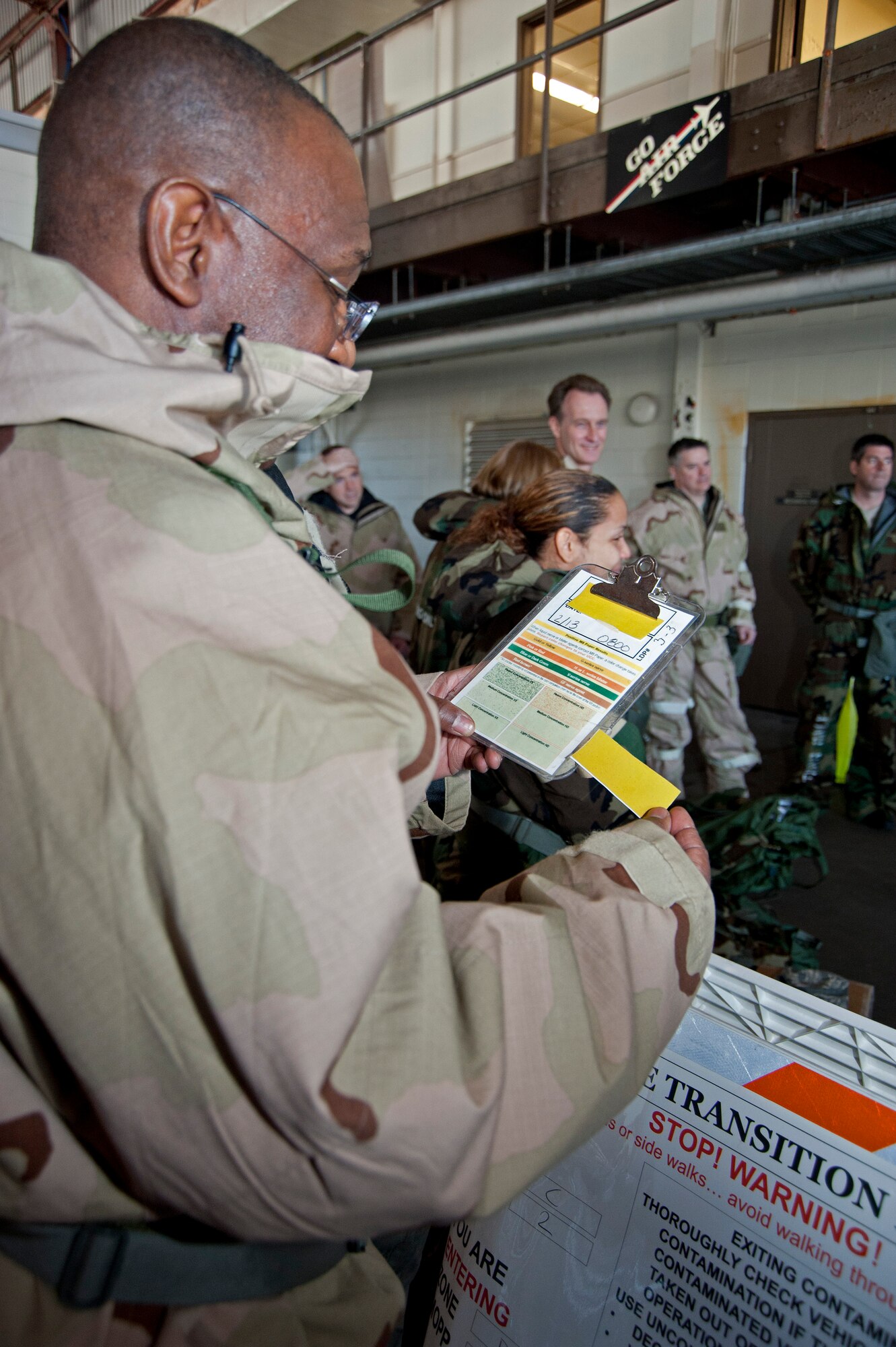 Lt. Col. Marshall Irvin, 403rd Mission Support Group commander, compares a simulated contaminated M8 chemical detection paper with a training aid Feb. 13, during the Unit Training Assembly.  Reservists from the 403rd Wing continue to train for the January 2012 Operational Readiness Inspection. (U.S. Air Force photo by Dhiana McKaig)