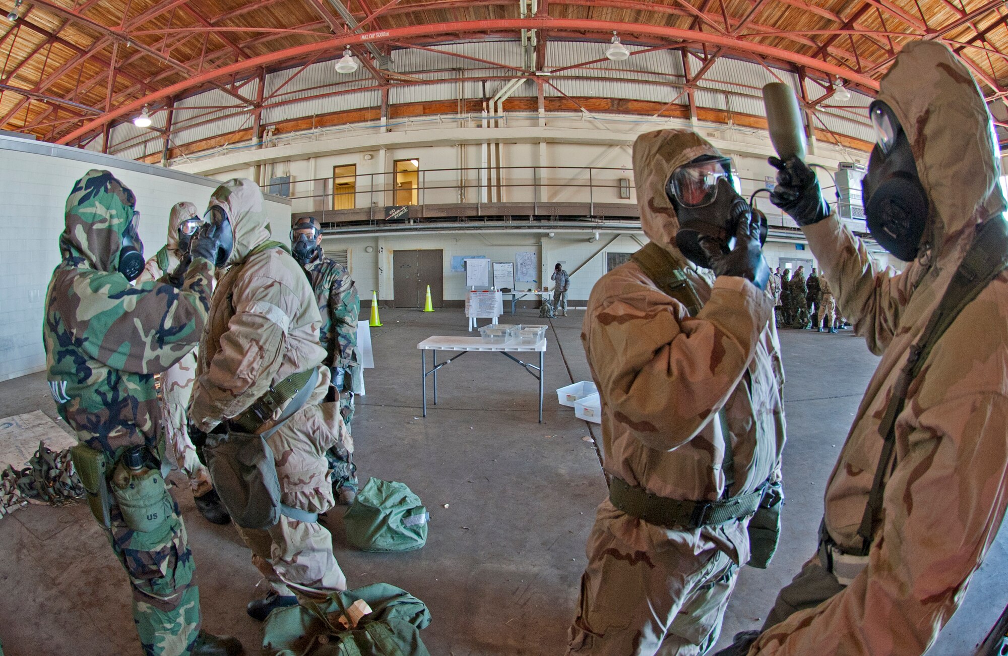 Lt. Col. Jeff Ragusa, 403rd Wing chief of safety, buddy checks Senior Airman Leon Hampton, 403rd Civil Engineer Squadron, while Senior Master Sgt. Michael Wieckowski and Tech. Sgt. David Delegrin, 403rd CES, practice hydration techniques through the M50 Joint Service General Purpose Field Masks Feb. 13, during the Unit Training Assembly.  Reservists from the 403rd Wing, Keesler Air Force Base, Miss., continue to prepare for the January 2012 Operational Readiness Inspection.