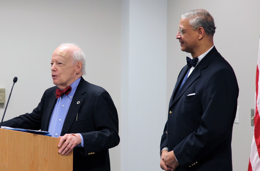 Retired Air Force Reserve Col. Edmund Effort, right, president of the local Tuskegee Airman Chapter looks on and listens as Wendell Freeland, left, an original Tuskegee Airman and member of the local chapter of Tuskegee Airmen, tells the story of his experiences of segregation during World War II during a Community College of the Air Force graduation ceremony.   Colonel Effort was presented with a check for the Tuskegee Airman's Scholarship Fund.  (U.S. Air Force photo by A1C Melissa Knox)