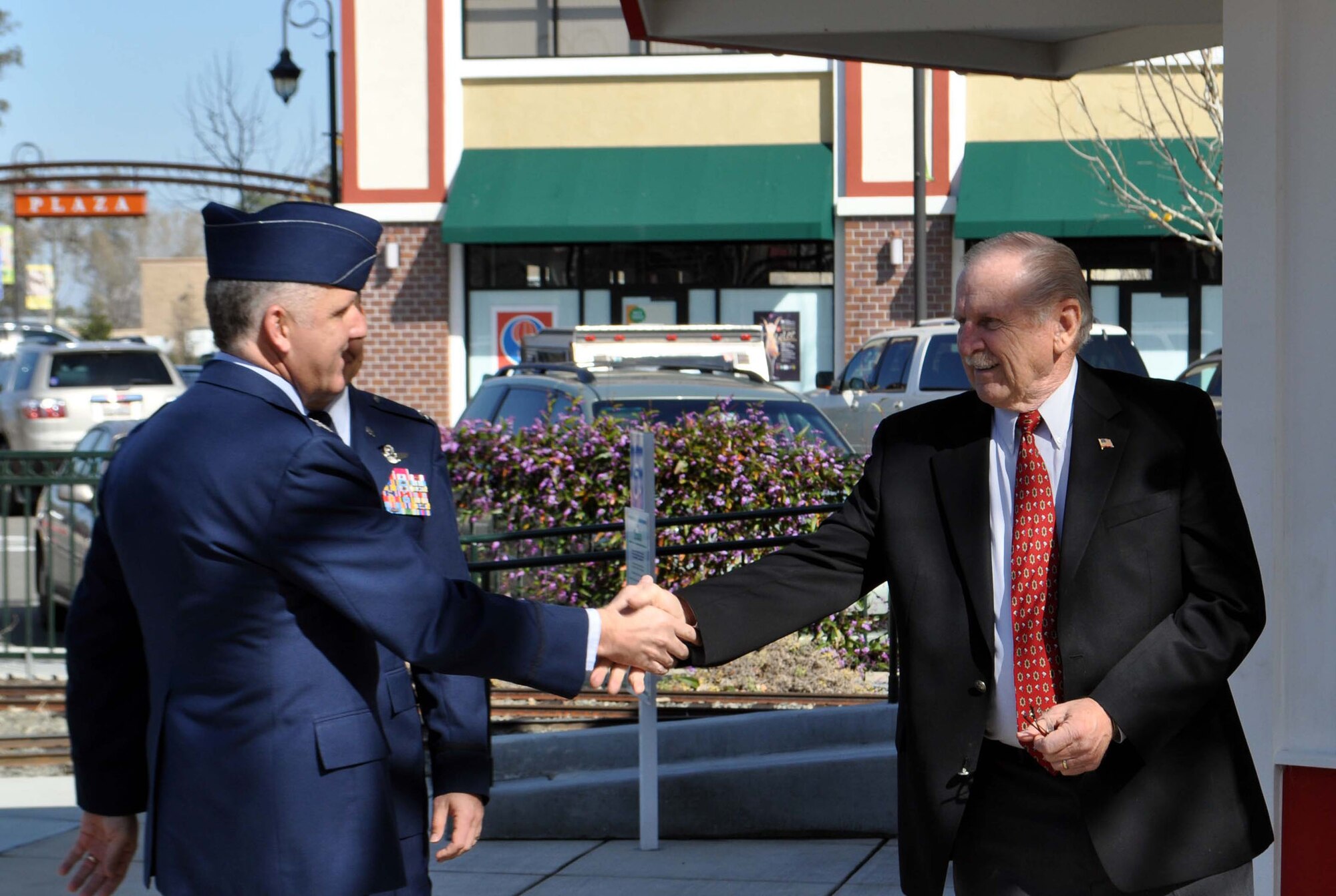 TRAVIS AIR FORCE BASE, Calif. -- Col. Jay Flournoy, commander of the Reserve’s 349th AMW, congratulates former Vacaville Mayor Len Augustine on his induction into the Nut Tree Plaza Wall of Fame. The former mayor was instrumental in the revitalization of the Plaza after it closed and fell into disrepair. The Nut Tree Plaza was a beloved local attraction in Northern California, and is now restored to its original splendor, boasting a park with a carousel and miniature train, shops, businesses and restaurants. Col. Flournoy and Team Travis share in strong community ties with Vacaville, and the other cities in Solano County. (U.S. Air Force photo/Senior Master Sgt. Ellen L. Hatfield)