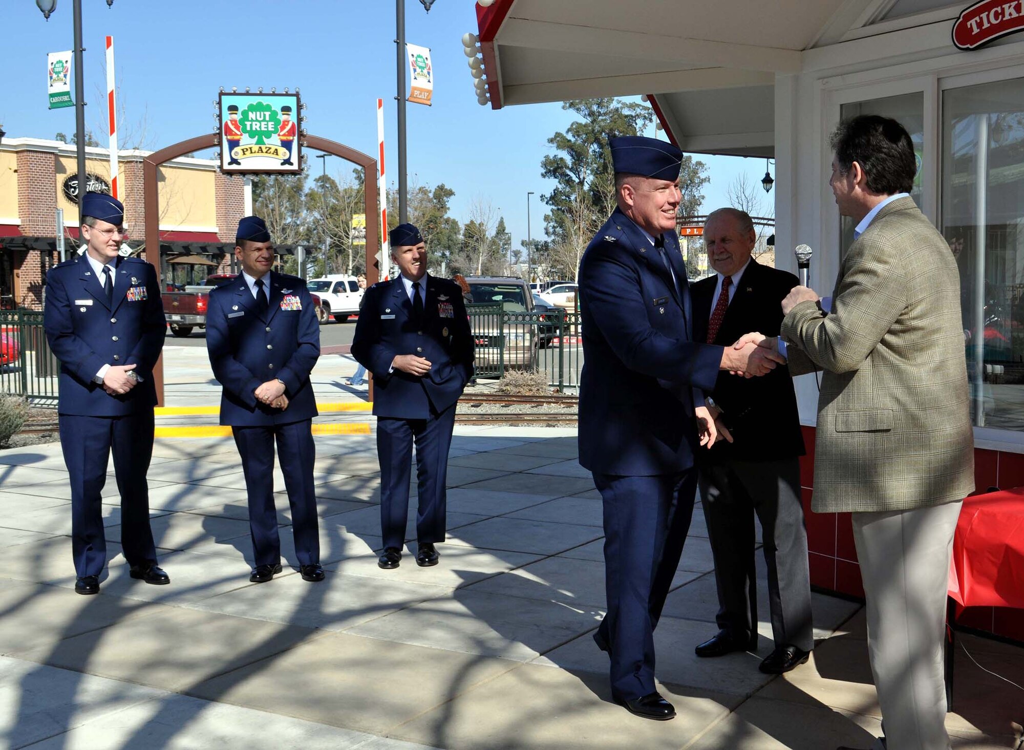 TRAVIS AIR FORCE BASE, Calif. -- Team Travis commanders were out in force, in service dress, Feb. 13, to honor former Vacaville Mayor, Len Augustine. Col. John Lipinski, vice commander, 15th Expeditionary Mobility Task Force, shakes hands with owner Rick Capretta.  Standing behind him are, from the left: Col. John Payne, vice commander, 615th Contingency Response Wing, Col. James Vechery, 60th Air Mobility Wing commander, and Col. Jay Flournoy, commander, 349th AMW. (U.S. Air Force photo/Senior Master Sgt. Ellen L. Hatfield)
