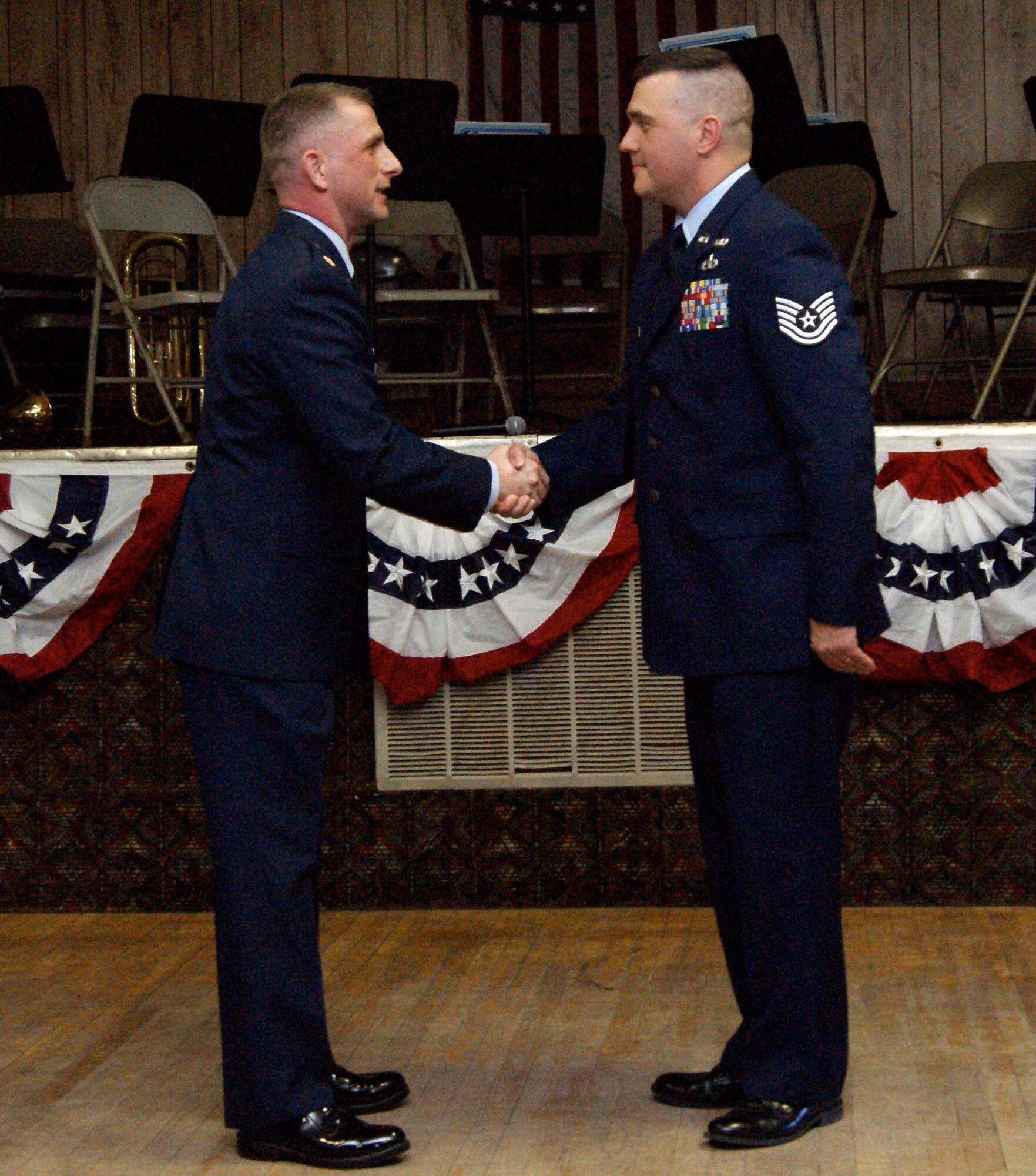 Maj. Darrin DeReus, 22nd Comptroller Squadron commander, shakes hands with Tech. Sgt. Wayne Herold, 22nd Air Refueling Wing Ground Safety technician, Feb. 9, 2011, Burwell, Neb.  On his own accord, Sergeant Herold researched and campaigned to help Mr. Gordon Ballagh, World War II veteran, receive his medals after more than 65 years.  (courtesy photo)