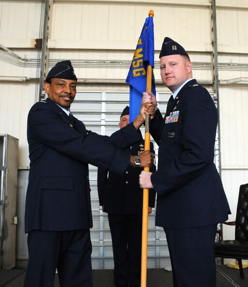 MacDill Air Force Base, Fla. -- Colonel Rodney Brian, commanding officer of the 927th Mission Support Group, passes the guidon of the 927th Logistics Readiness Squadron onto Capt. Gregory Wedding during a change of command ceremony here Feb. 12.  Wedding assumed command of the unit surrounded by his troops, parents, and commanding officer of the 927th Air Refueling Wing. (Official United States Air Force photo by Staff Sgt. Shawn C. Rhodes)