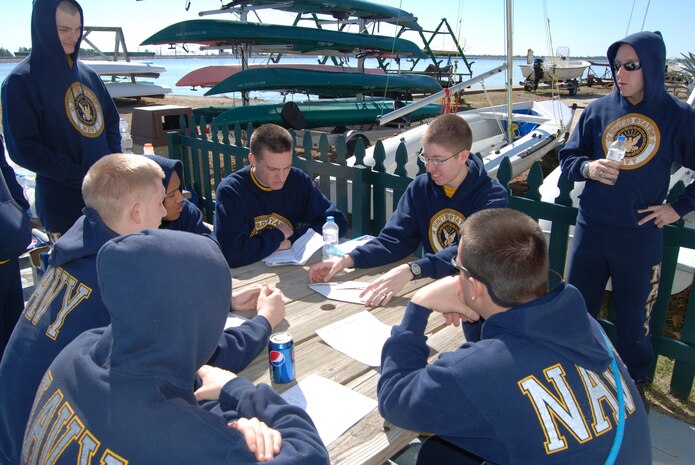 An officer candidate from the Citadel’s Navy Reserve Officers Training Corps shows other officer candidates and midshipmen the points of sail using a paper boat as a model at Short Stay Outdoor Recreation Area in Moncks Corner, S.C., Feb. 12. Officer candidates and midshipmen from the Citadel routinely volunteer their free time at Short Stay on Lake Moultrie, repairing and cleaning boats and working on their sailing qualifications. Short Stay is open from 8 a.m. to 4 p.m. on weekends starting March 4 and will open seven days a week starting Memorial Day. Sail boats, kayaks, canoes, Jon boats, pontoon boats, center console skiffs, water skis, wake boards, knee boards and tubes are available for rent. For more information, call 843-743-2608 ext. 230.