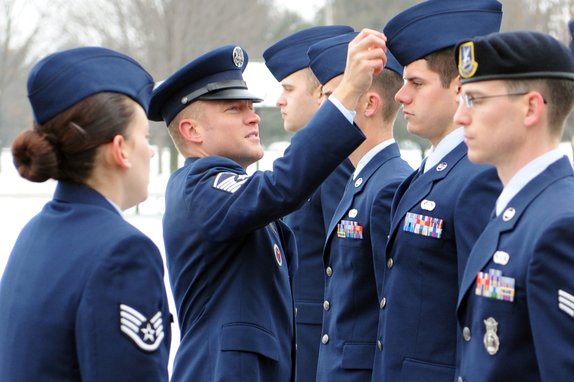 Master Sgt. Eric Matzek, 375th Force Support Squadron’s Airman Leadership School commandant, fixes the hat of Senior Airman Noah Erdman, ALS student, during class 11-B’s service dress uniform inspection Jan. 24, 2011 at Scott Air Force Base, Ill. Airmen have three uniform inspections during their 24 academic days at ALS.  (U.S. Air Force photo/Staff Sgt. Teresa M. Jennings)