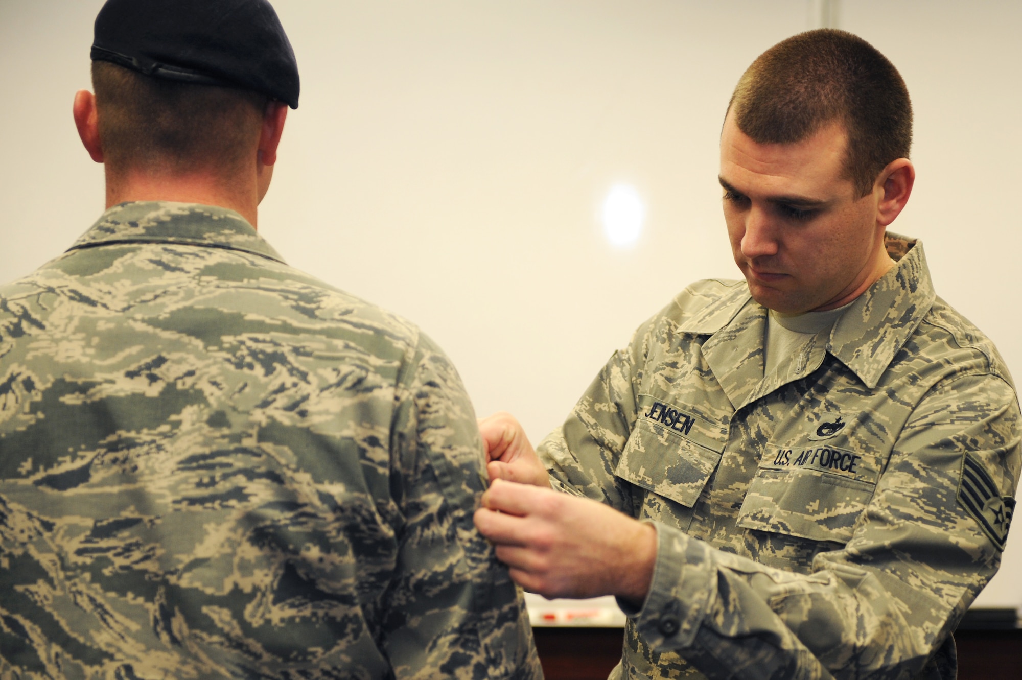 Staff Sgt. Casey Jensen 375th Force Support Squadron’s Airman Leadership School instructor, measures the width of a student’s stripes during ALS class 11-B’s ABU inspection Jan. 13, 2011 at Scott Air Force Base, Ill. During the 24 academic days Airmen spend at ALS they will have three uniform inspections, six tests and six writing assignments. (U.S. Air Force photo/Staff Sgt. Teresa M. Jennings)