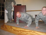 Senior Master Sgt. Mark Stolar, along with other reservists in the 567th RED HORSE, do push ups to celebrate their birth month. Better than a piece of cake! (USAF photo by SrA Jasmine Ealey, 567 RHS)