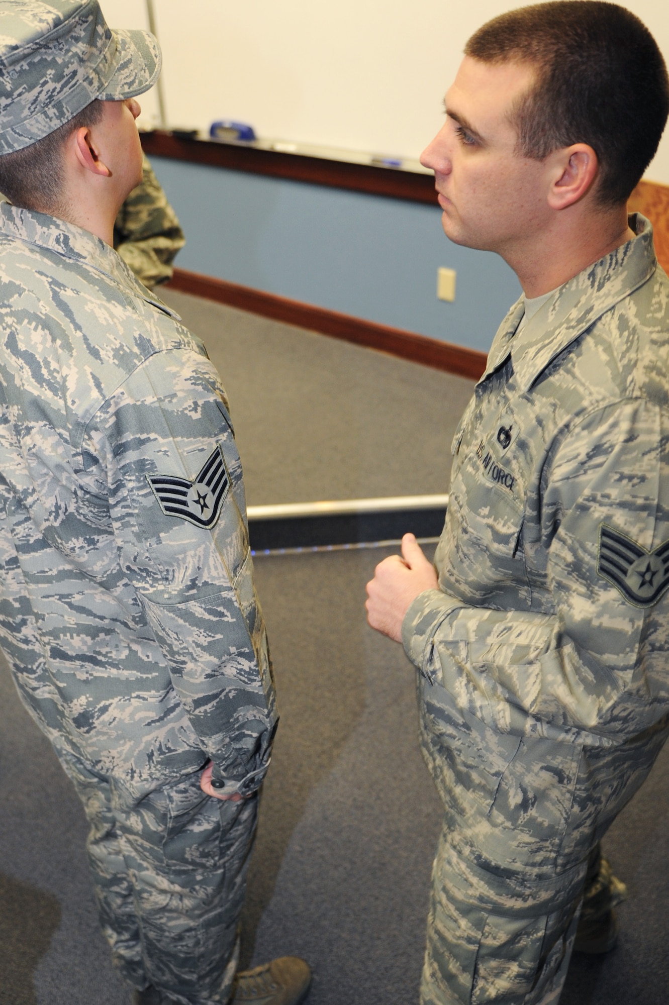 Staff Sgt. Casey Jensen, 375th Force Support Squadron’s Airman Leadership School instructor, inspects a student’s uniform during an ABU inspection for class 11-B, Jan. 13, 2011 at Scott Air Force Base, Ill.  During the 24 academic days Airmen spend at ALS they will have three uniform inspections, six tests and six writing assignments. (U.S. Air Force photo/Staff Sgt. Teresa M. Jennings)