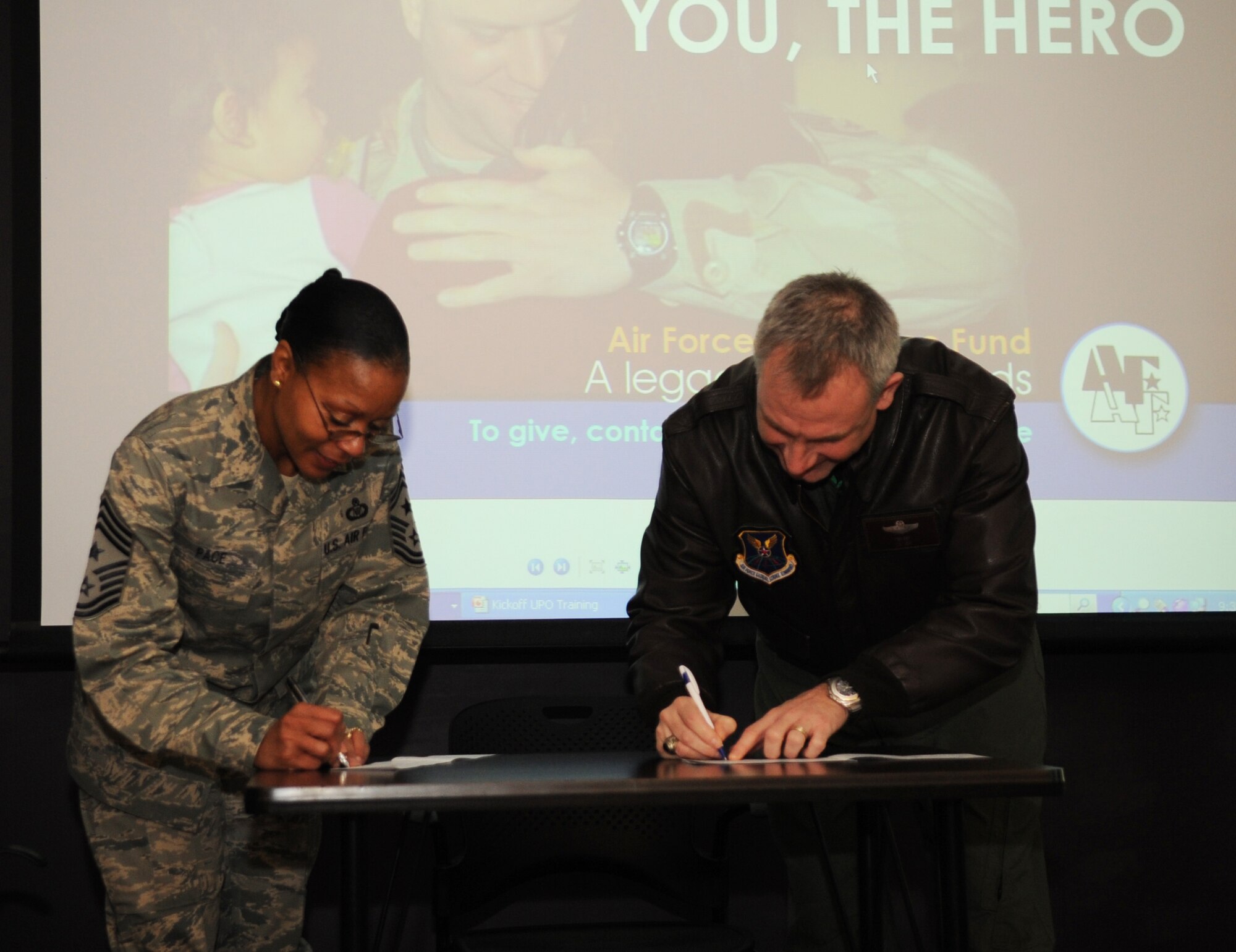 Chief Master Sgt. Jo Ann Pace, 2nd Bomb Wing command chief, and Col. Tim Fay, 2 BW commander, fill out Air Force Assistance Fund forms at Barksdale Air Force Base, La., Feb. 11. The AFAF officially started Feb. 14 and will end March 25. Barksdale has a goal of $130,000 to contribute to the fund that lends critical support to Airmen and their families -- active-duty, retired, officers and enlisted. The donations to the AFAF Campaign qualify for Internal Revenue Service charitable deductions. (U.S. Air Force photo/Senior Airman Alexandra M. Boutte) (RELEASED)