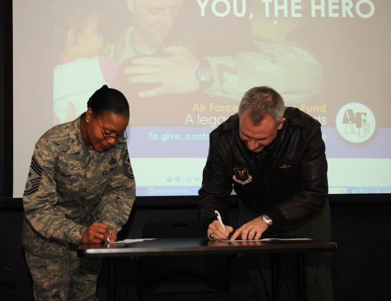 Chief Master Sgt. Jo Ann Pace, 2nd Bomb Wing command chief, and Col. Tim Fay, 2 BW commander, fill out Air Force Assistance Fund forms at Barksdale Air Force Base, La., Feb. 11. The AFAF officially started Feb. 14 and will end March 25. Barksdale has a goal of $130,000 to contribute to the fund that lends critical support to Airmen and their families -- active-duty, retired, officers and enlisted. The donations to the AFAF Campaign qualify for Internal Revenue Service charitable deductions. (U.S. Air Force photo/Senior Airman Alexandra M. Boutte) (RELEASED)