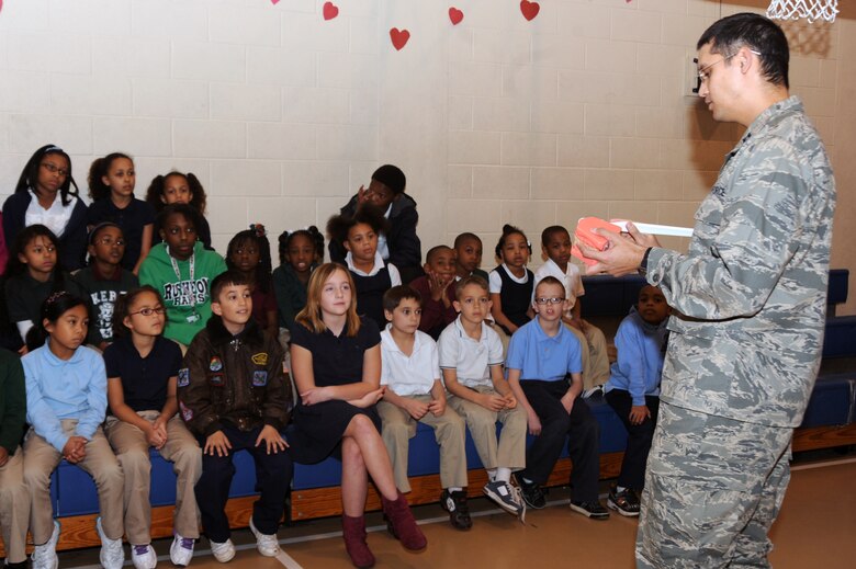 Capt. Donnie Pritchett, 2nd Dental Squadron dentist, demonstrates how to correctly brush teeth at the Barksdale Youth Center on Feb. 15. February is Children's Dental Health Month. (U.S. Air Force photo/Senior Airman Brittany Y. Bateman)(RELEASED)