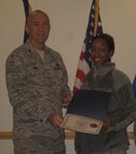 Col. Timothy Lamb, commander of the 567th RED HORSE Squadron, promotes Reservist Britani Mikell to the rank of Senior Airman during the squadron's January training weekend. ((USAF photo by SrA Jasmine Ealey, 567RHS)