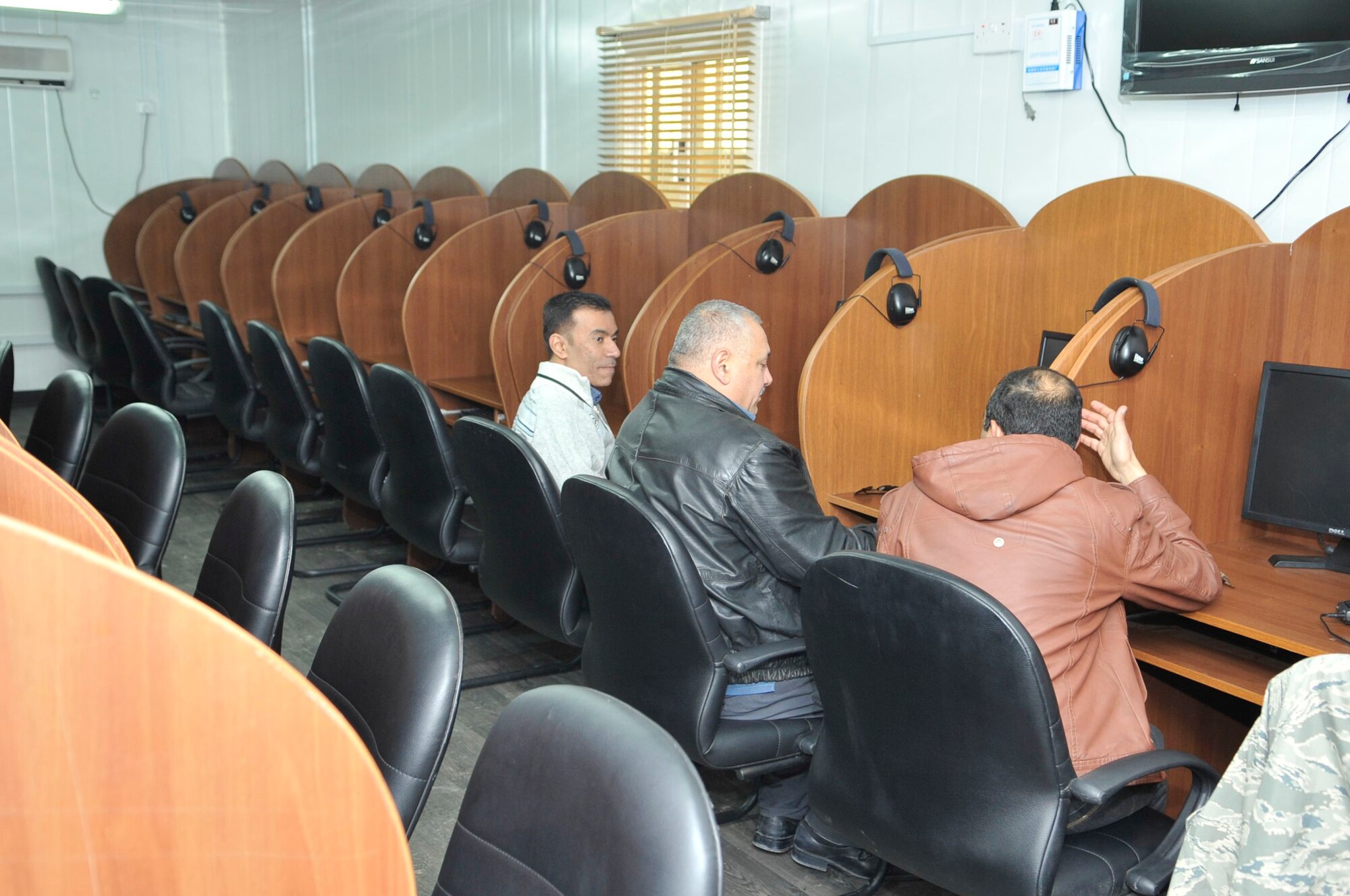 Iraqis sit at work stations waiting to take an English proficiency test Feb. 6, 2011, at Forward Operating Base Union III, Iraq. (U.S. Air Force photo/Senior Master Sgt. Larry Schneck)
