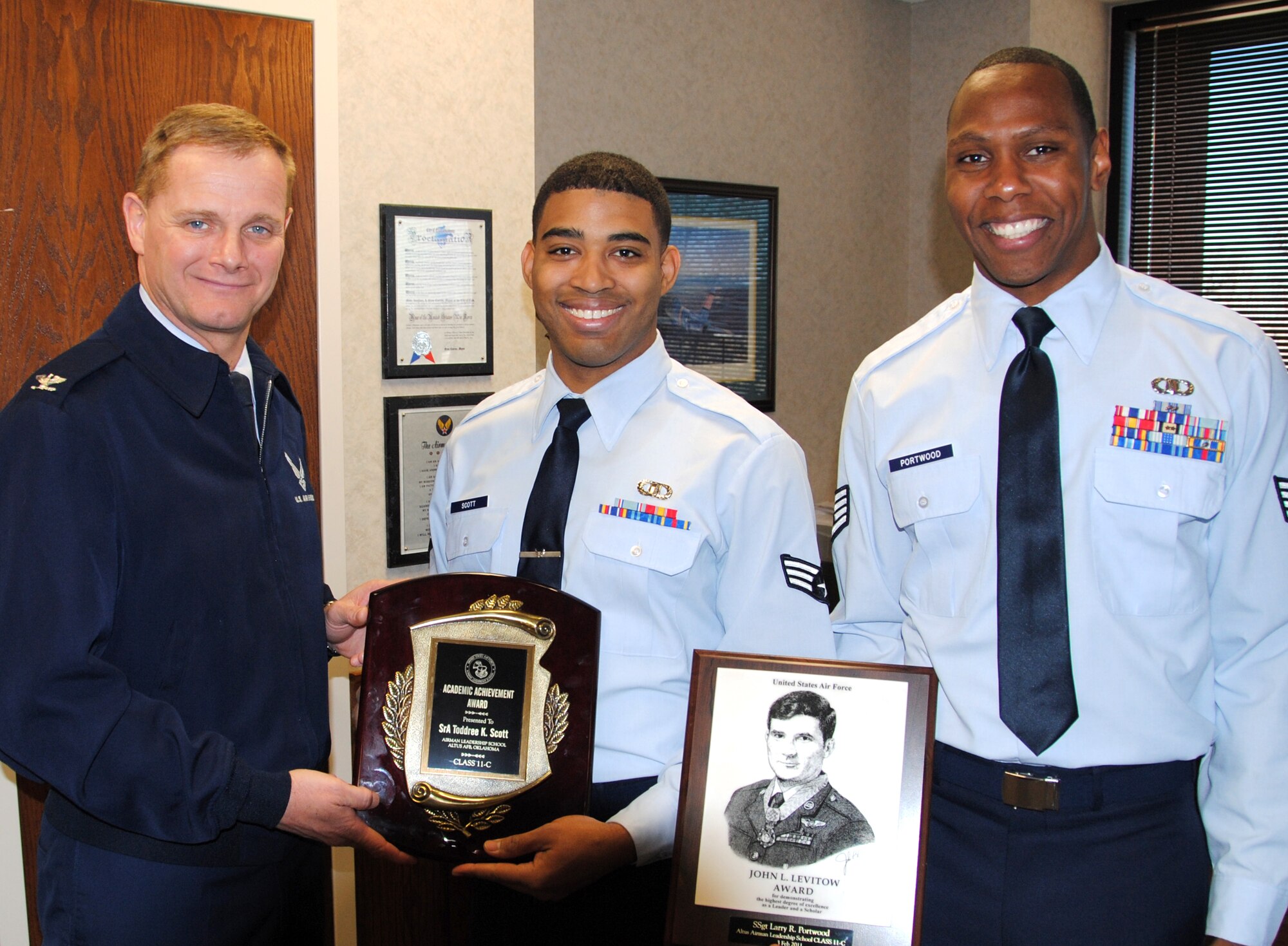 Staff Sgt. Larry Portwood, right, and Senior Airman Toddree Scott, center, are congratulated by Col. Russ Mack, left, 71st Flying Training Wing commander, for awards earned while attending the Airman Leadership School at Altus AFB, Okla. Sergeant Portwood received the John L. Levitow Award. Airman Scott received the Academic Achievement Award. (U.S. Air Force photo)
