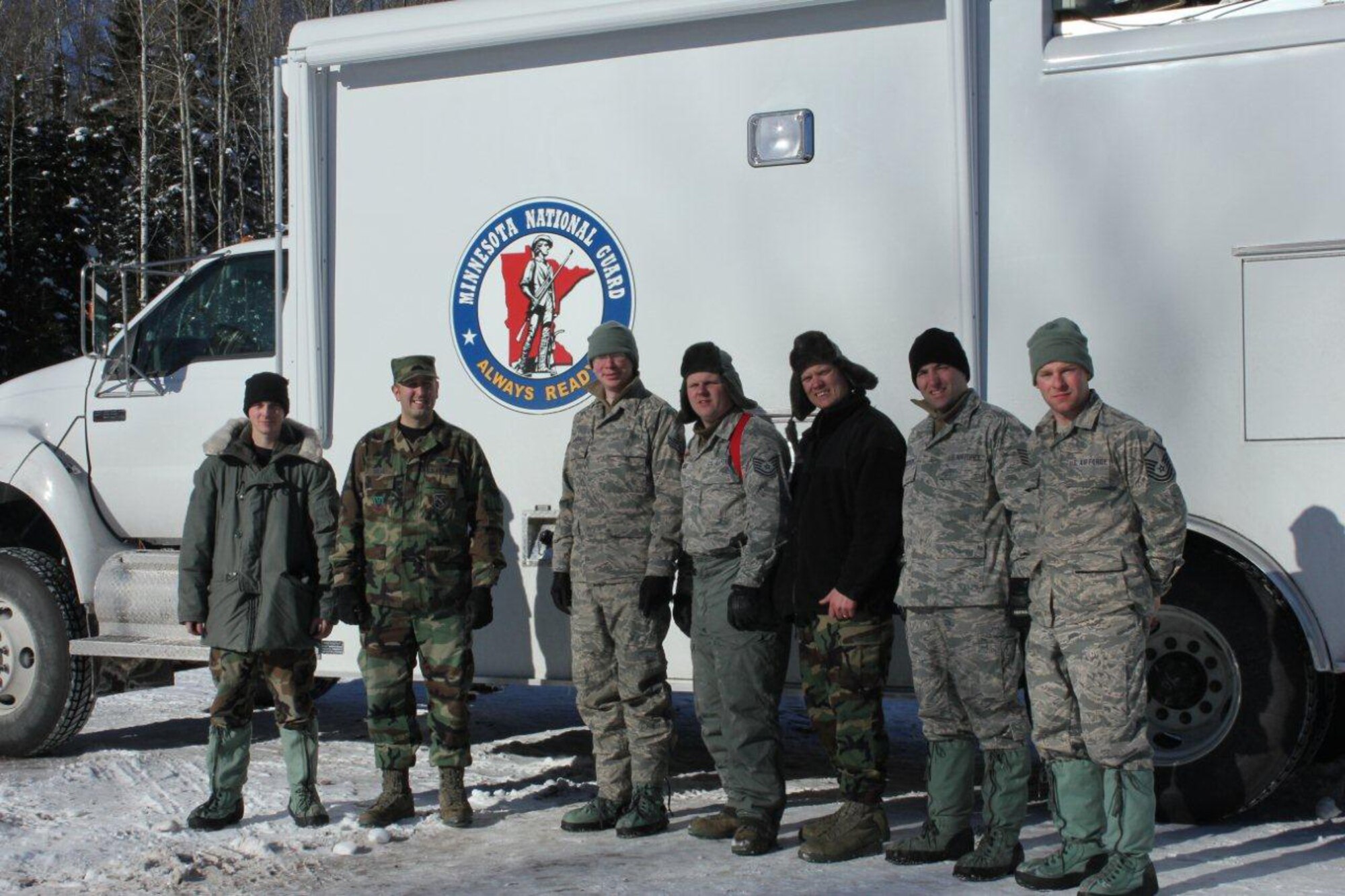 Members of the 148th Fighter Wing, Communication Flight, Deployable Interoperable Communications Element (DICE) take time to pose for a group picture.  The DICE team was deployed to the Grand Marais, Minn. area in support of the John Beargrease Sled Dog Marathon.  U.S. Air Force photo by MSgt Richard Kaufman.  (Released)

