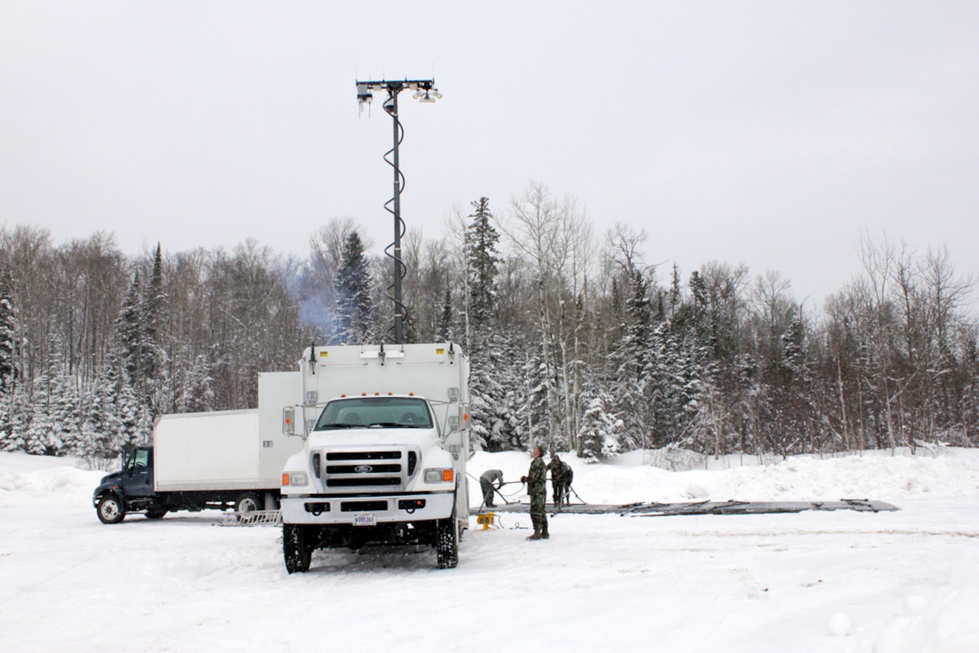 Members of the 148th Fighter Wing, Communications Flight, Deployable Interoperable Communications Element (DICE) are seen setting up equipment at their deployed location in support of the John Beargrease Sled Dog Marathon.  The 148th Communication Flight has been supporting the Beargrease Sled Dog Marathon since 1995.  U.S. Air Force photo by MSgt Richard Kaufman.  (Released)

