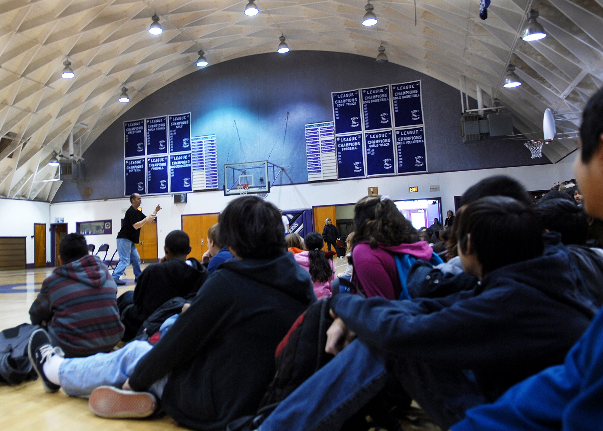 Sixth-, seventh- and eighth-grade students from Branch Elementary School and Desert Junior-Senior High look on as Cary Trivanovich uses pantomime to address bullying in schools. For over 25 years, Mr. Trivanovich has been speaking to students in schools across America hoping to inspire change in the way kids treat each other. (Air Force photo by Kate Blais)