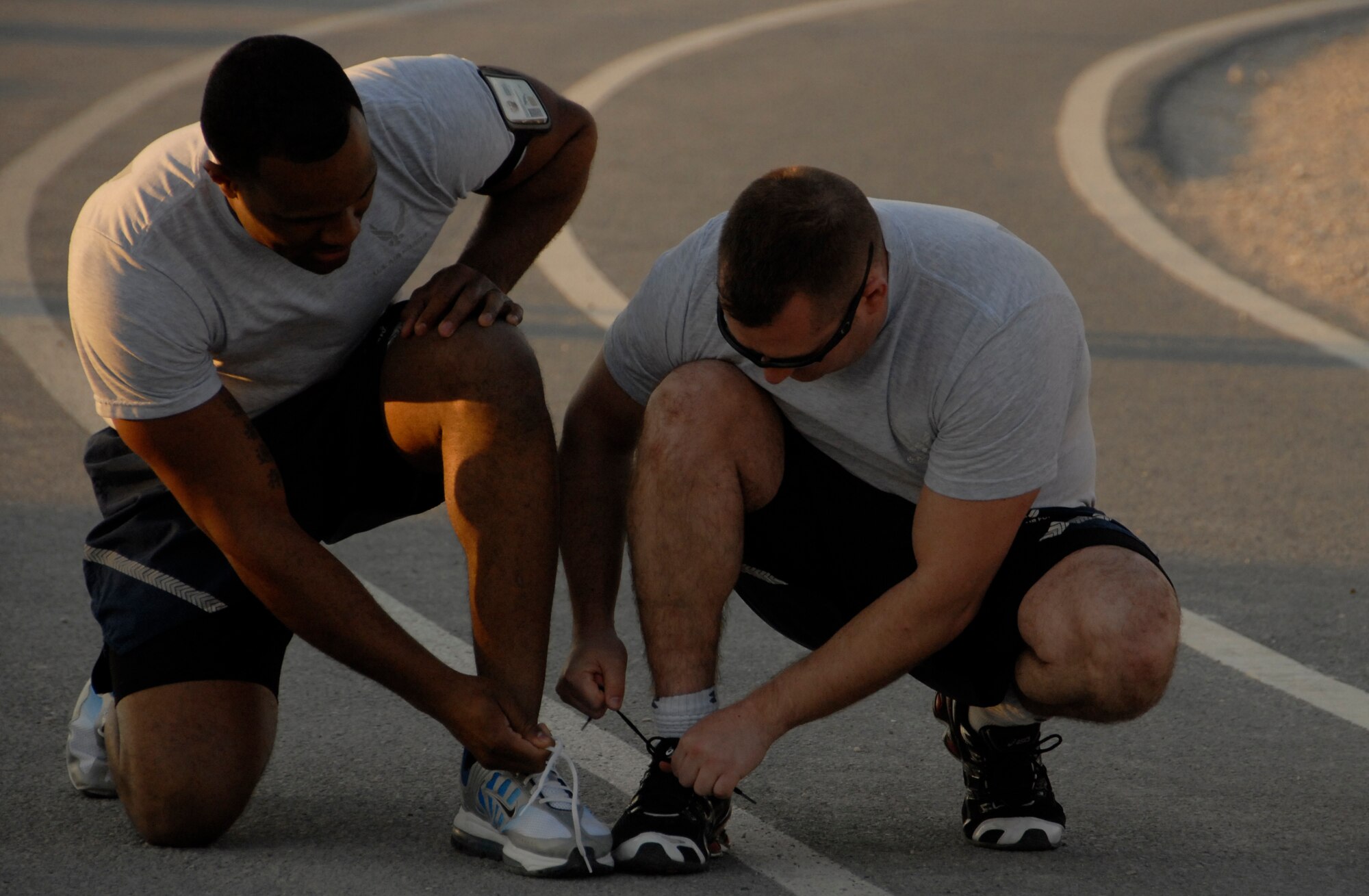 Senior Airman Leonard Patterson and Tech. Sgt. Shawn Ingle participate in the 3 legged race during the old school sports event on base Feb. 12. (U.S. Air Force photo/Staff Sgt. Christian Jadot)