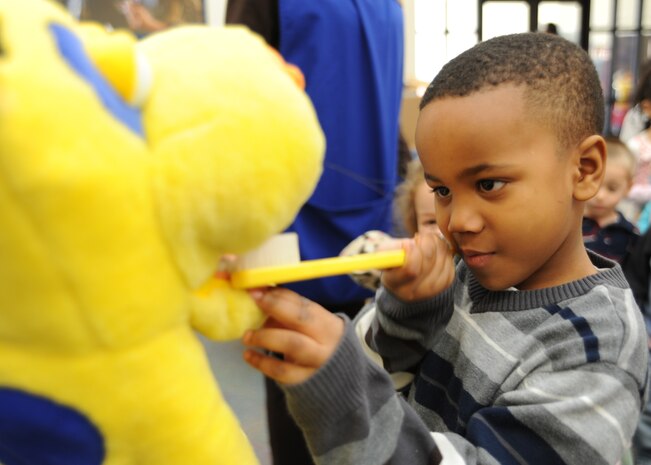 Dacien Owens practices proper brushing techniques during the dental clinic visit to the Mikolajcik Child Development Center on Joint Base Charleston - Air Base, Feb. 14. Dacien is the son of Staff Sgts. Dwaine and Dominique Washington. (U.S. Air Force photo/Senior Airman Katie Gieratz)