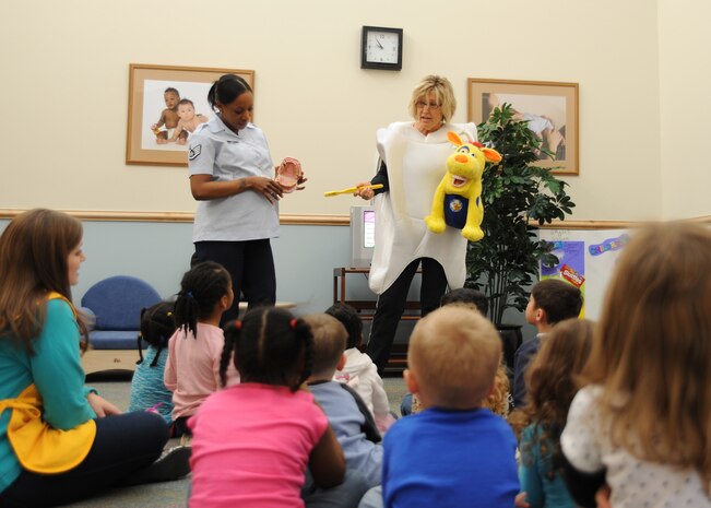 Staff Sgt. Ebony Holt and Ms. Gaye Adams speak to pre-schoolers at the Mikolajcik Child Development Center on Joint Base Charleston - Air Base, Feb. 14. The visit was to teach children about good dental hygiene. Sergeant Holt is a medical technician and Ms. Adams is a dental hygienist. Both are assigned to the 628th Medical Group. (U.S. Air Force photo/Senior Airman Katie Gieratz)