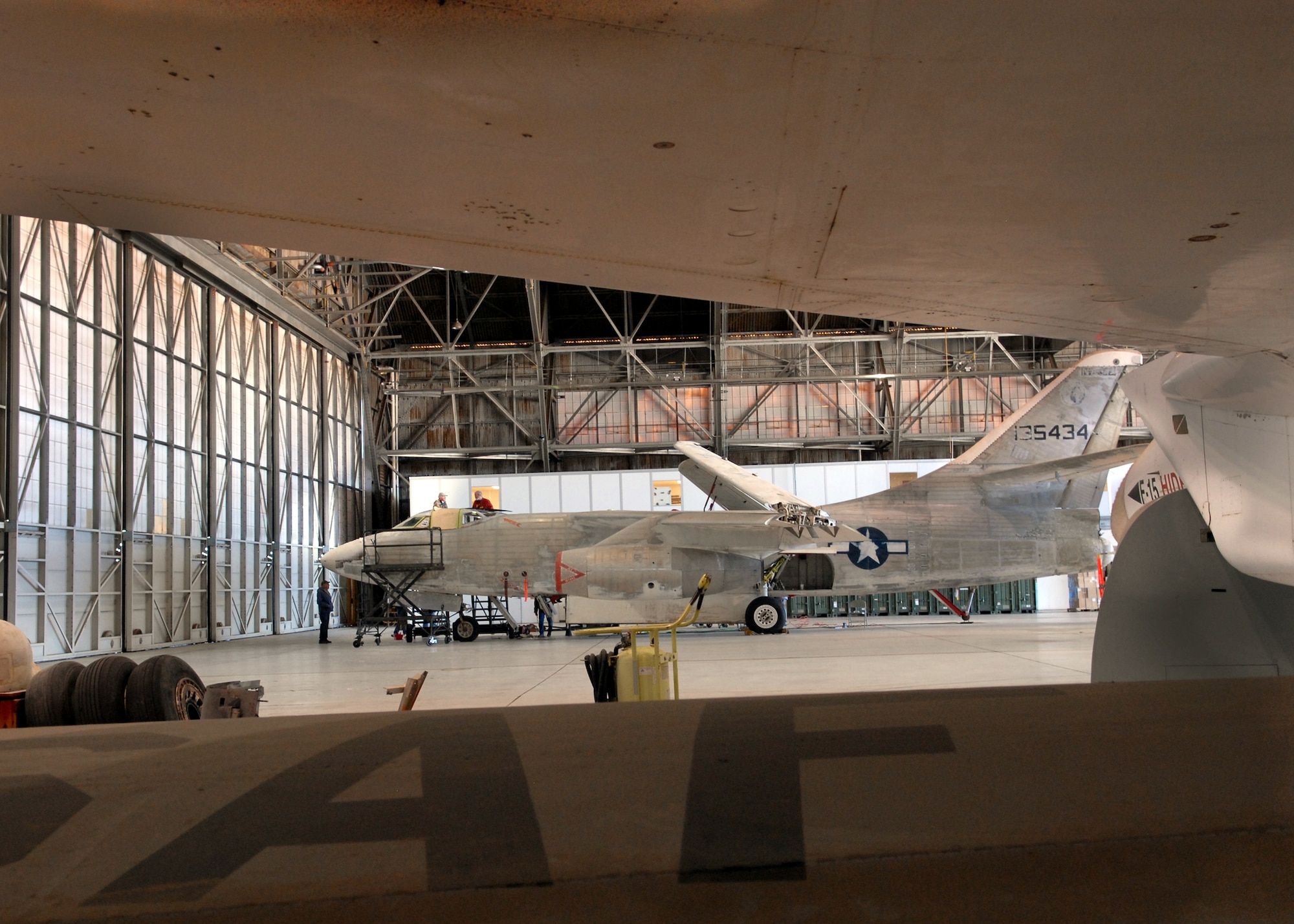 A Navy A3D-1 Skywarrior from 1955 waits patiently in Hangar 1210 as a crew of retired Navy veterans works to restore the aircraft. Since January 2010, 10 retired sailors travel to Edwards for one week each month to re-fabricate the aircraft, replace parts of the cockpit and eventually re-paint the exterior. (Air Force photo by Kate Blais)