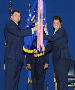 LANGLEY AIR FORCE BASE, Va. -- Col. Mark Johnson, 635th Supply Chain Operations Wing commander, passes the 735th Supply Chain Operations Group guidon to Col. Linda Hurry, the new 735 SCOG commander, during an assumption of command ceremony at the static display hangar Feb. 14. Colonel Hurry succeeded Col. Rick Bennett in command of the group. (U.S. Air Force photo/Staff Sgt. Ashley Hawkins) (RELEASED)