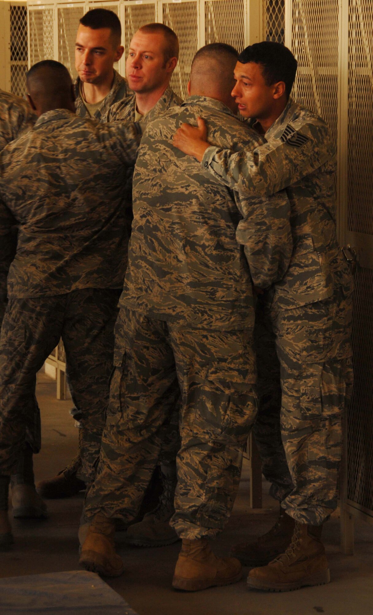 Deployed firefighters from Kadena Air Base, Japan, mourn the loss of Senior Airman Derek Kozorosky during a memorial ceremony at their deployed location in Southwest Asia, Feb. 16.  Seven deployed co-workers of Airman Kozorosky are currently serving in the U.S. Air Forces Central area of responsibility.  Airman Kozorosky died Feb. 11 at Kadena following a vehicle incident.  (U.S. Air Force photo/Staff Sgt. Anthony Graham)