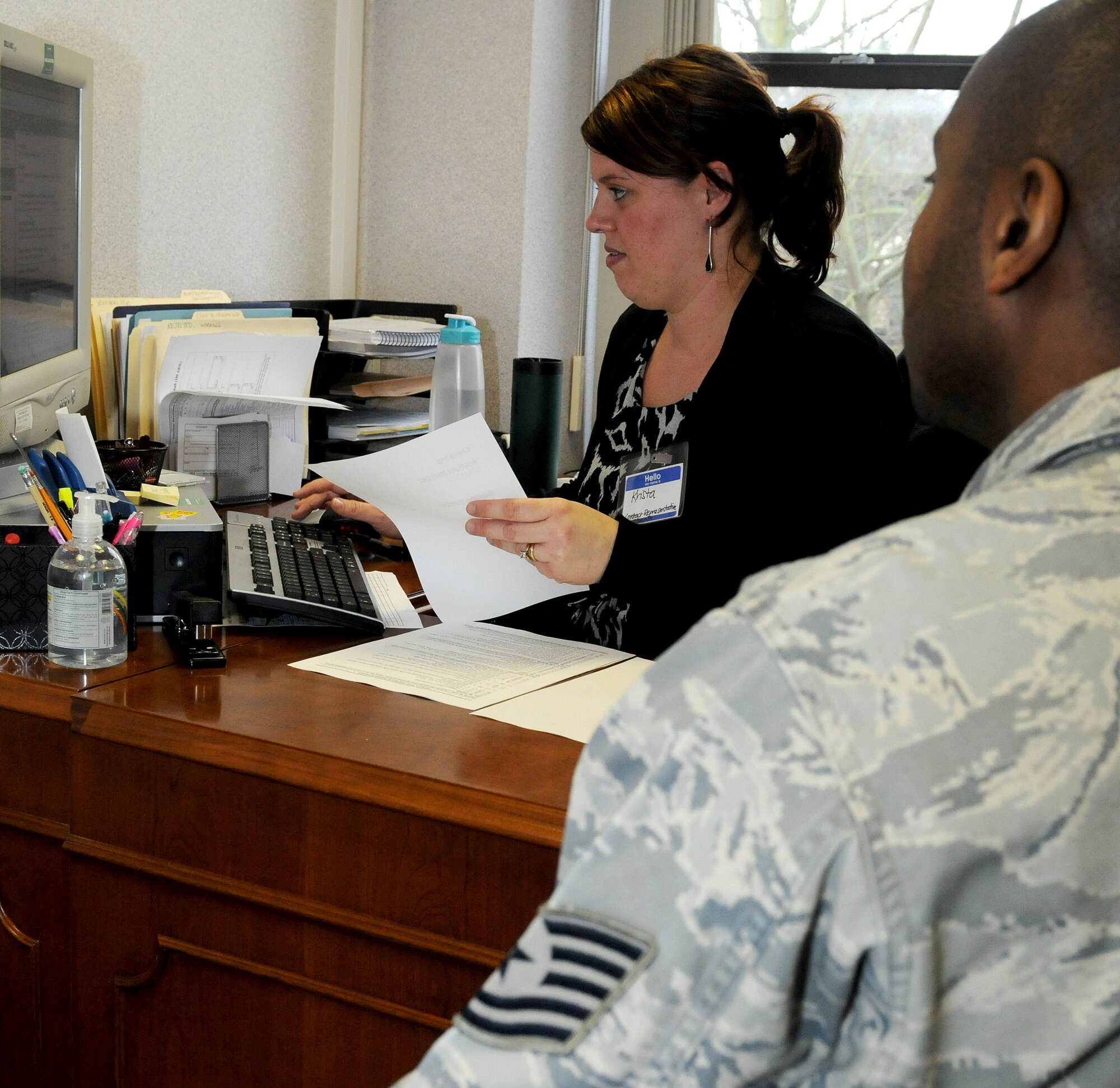 RAF MILDENHALL, England--Krista Kenney, 100th ARW Legal Office Tax Center contact representative, assists Tech. Sgt. Darryll Stewart, 100th Force Support Squadron, with filing his 2010 federal income taxes.  The tax center is located on the second floor of Building 424. Their business hours are Mondays through Wednesdays from 9 a.m. to noon and 1 to 4 p.m., and Thursdays and Fridays from 9 a.m. to noon. They also allow walk ins for airman 1st class and below from noon to 4 p.m. on Thursdays. (U.S. Air Force photo/Senior Airman Tabitha M. Lee)